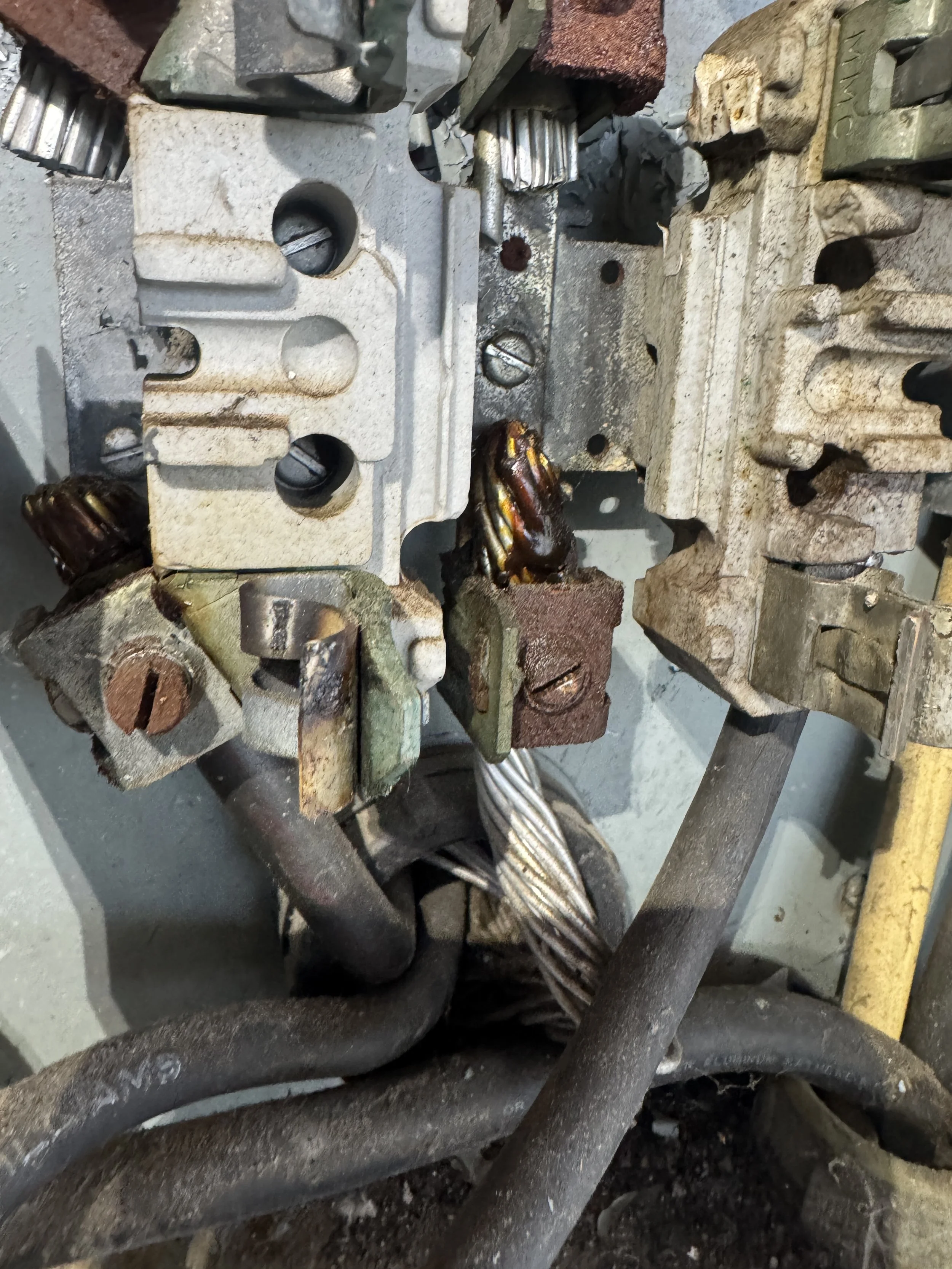 Corroded terminals and bar inside a Suffolk, VA enclosure that has taken on water