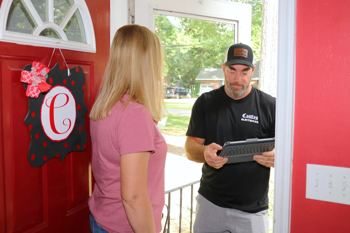 Castles Electrical electrician greeting a homeowner at the front door