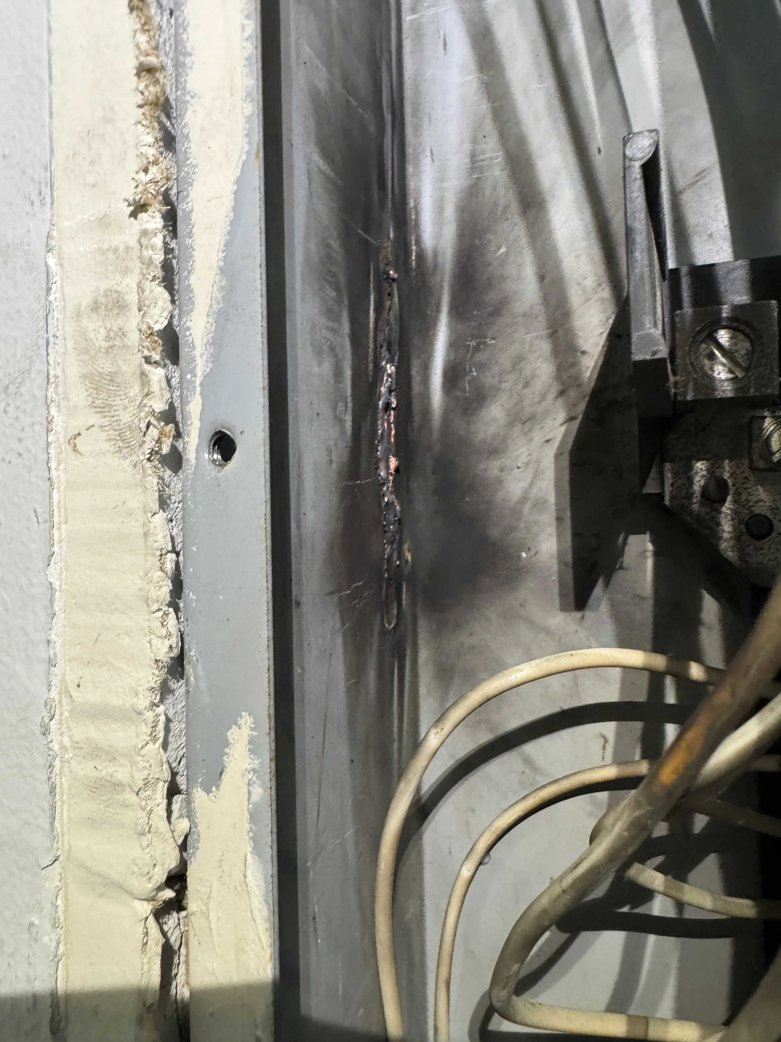 Scorch marks inside a Norfolk, VA panel enclosure found during a service call
