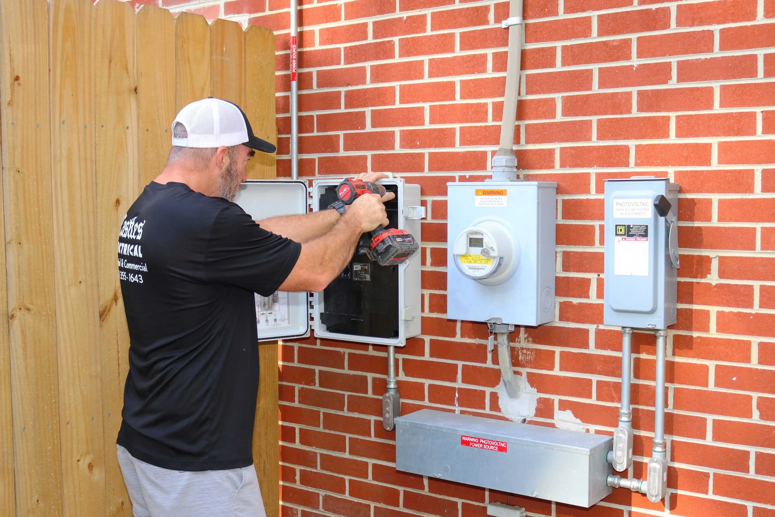 Castles Electrical electrician working at the service equipment of a Suffolk, VA home