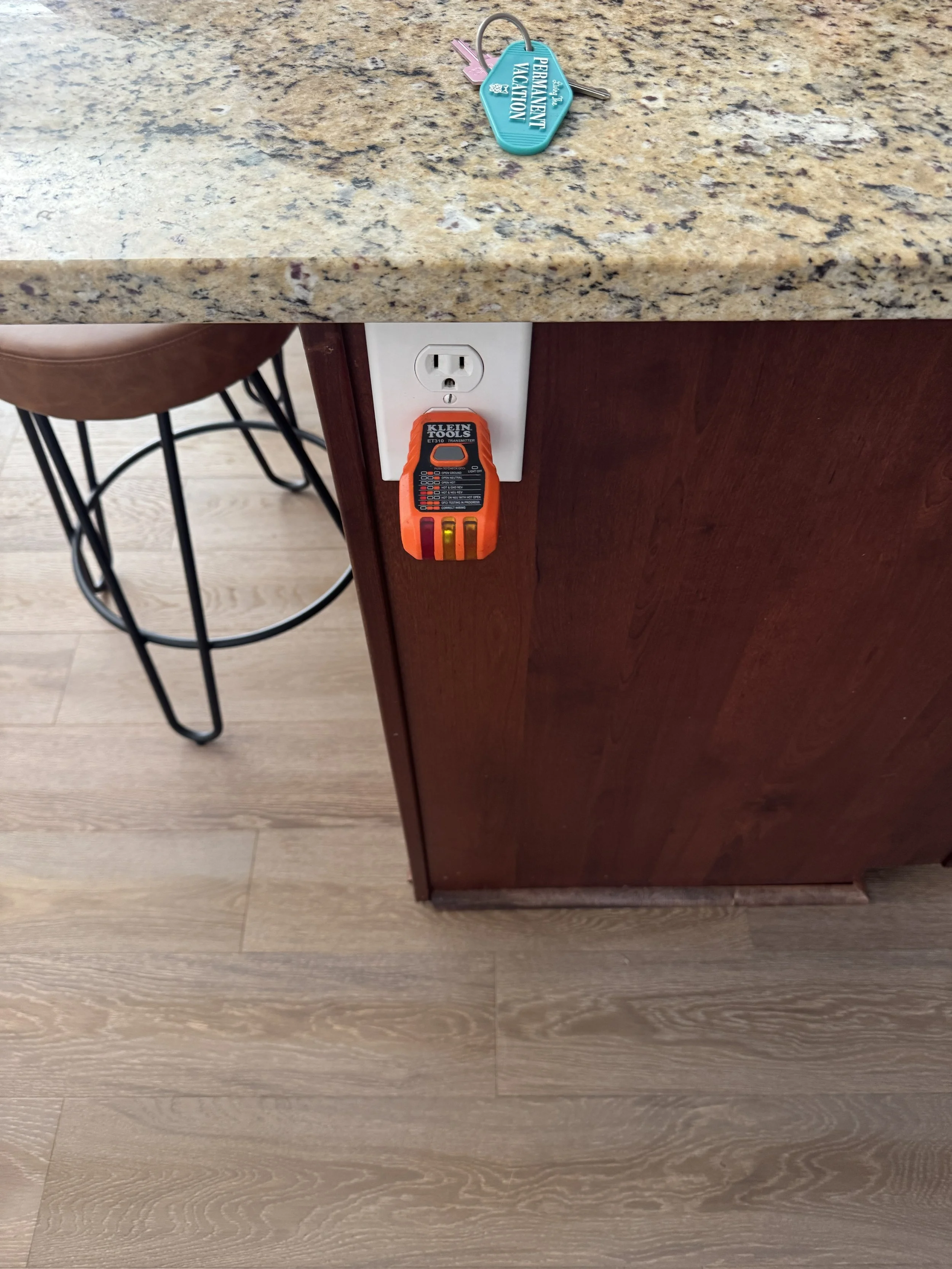 Receptacle in the side of a kitchen island being tested in a Portsmouth, VA home