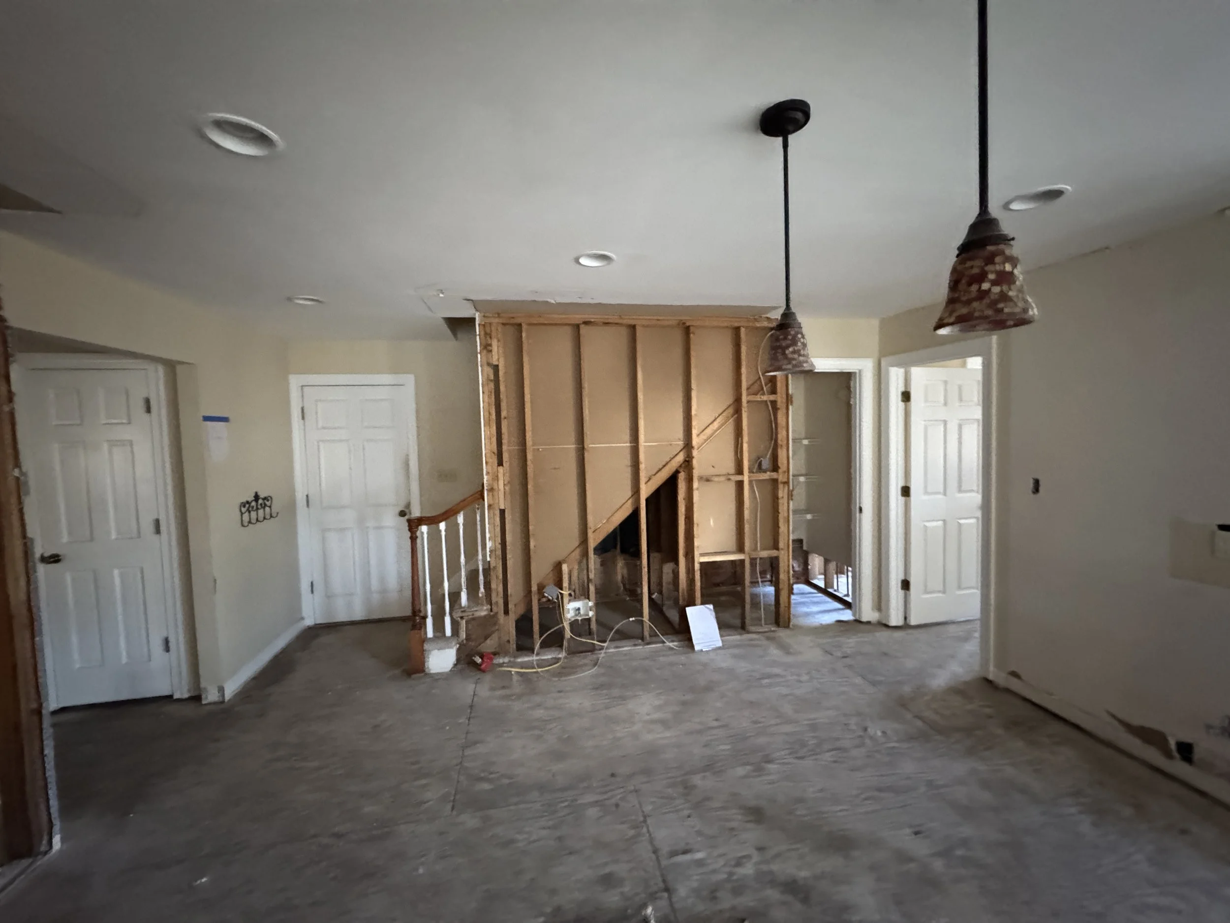 Room in an older Suffolk, VA house with a wall opened to the framing