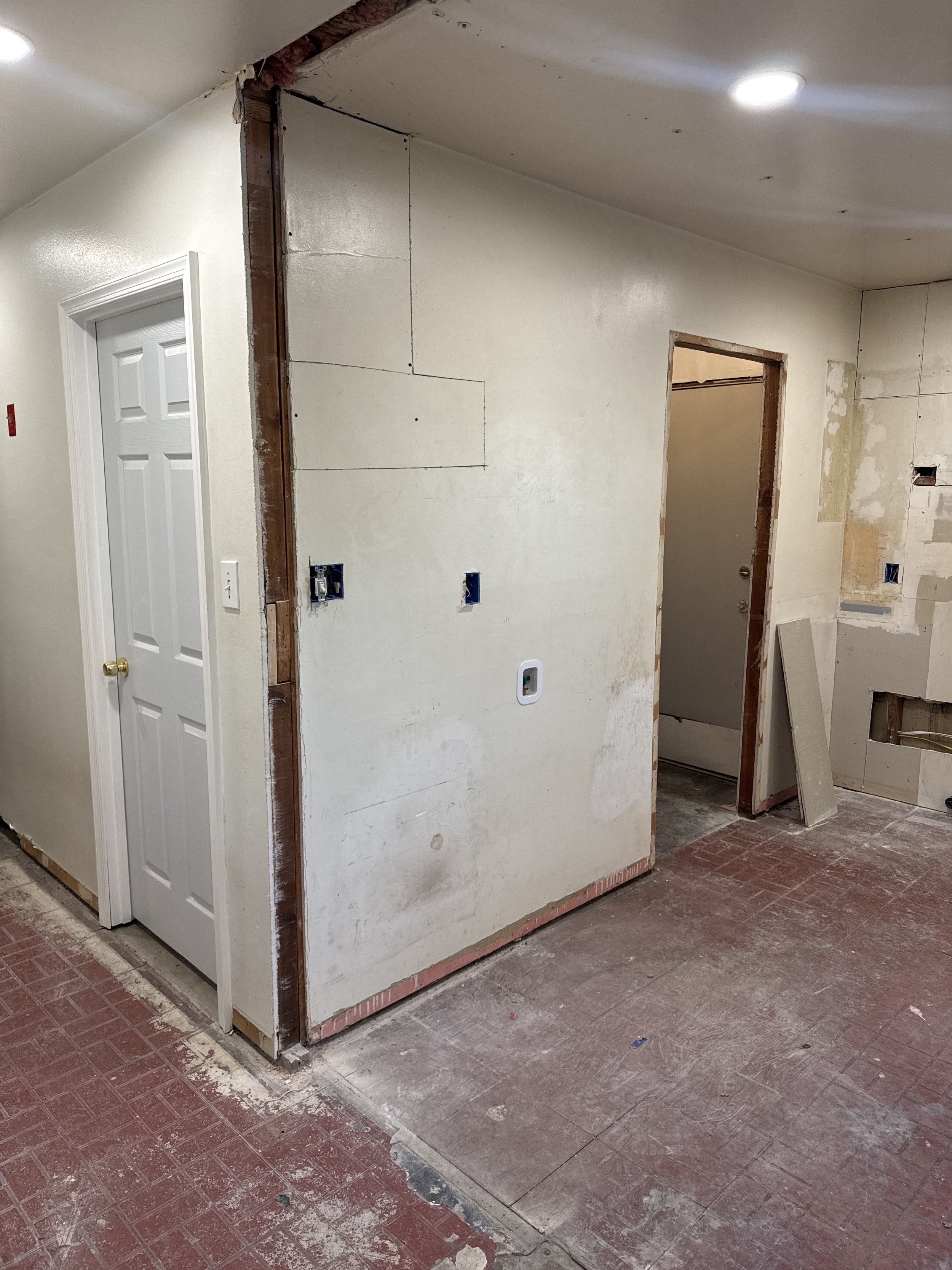 Older Norfolk, VA home with a wall opened back to the framing during rewiring