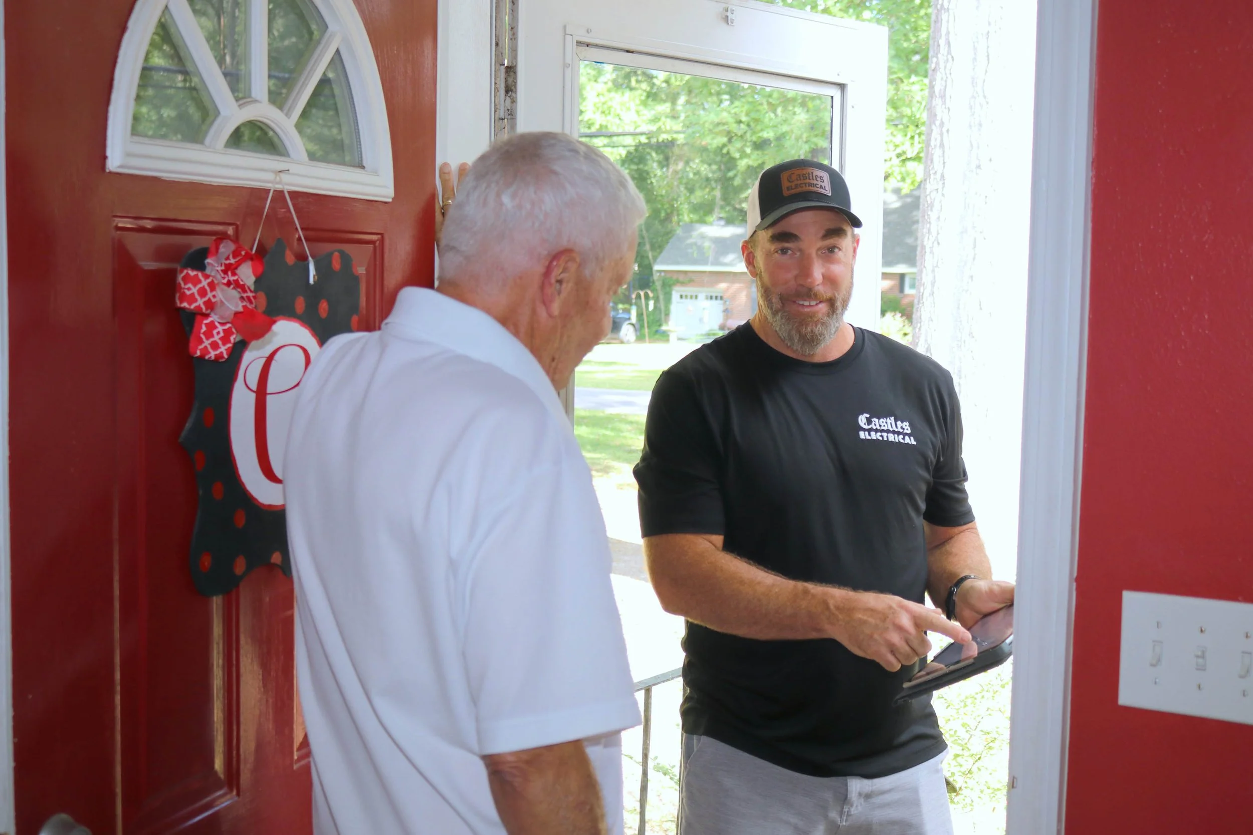 Castles Electrical electrician going over the visit with a Portsmouth homeowner