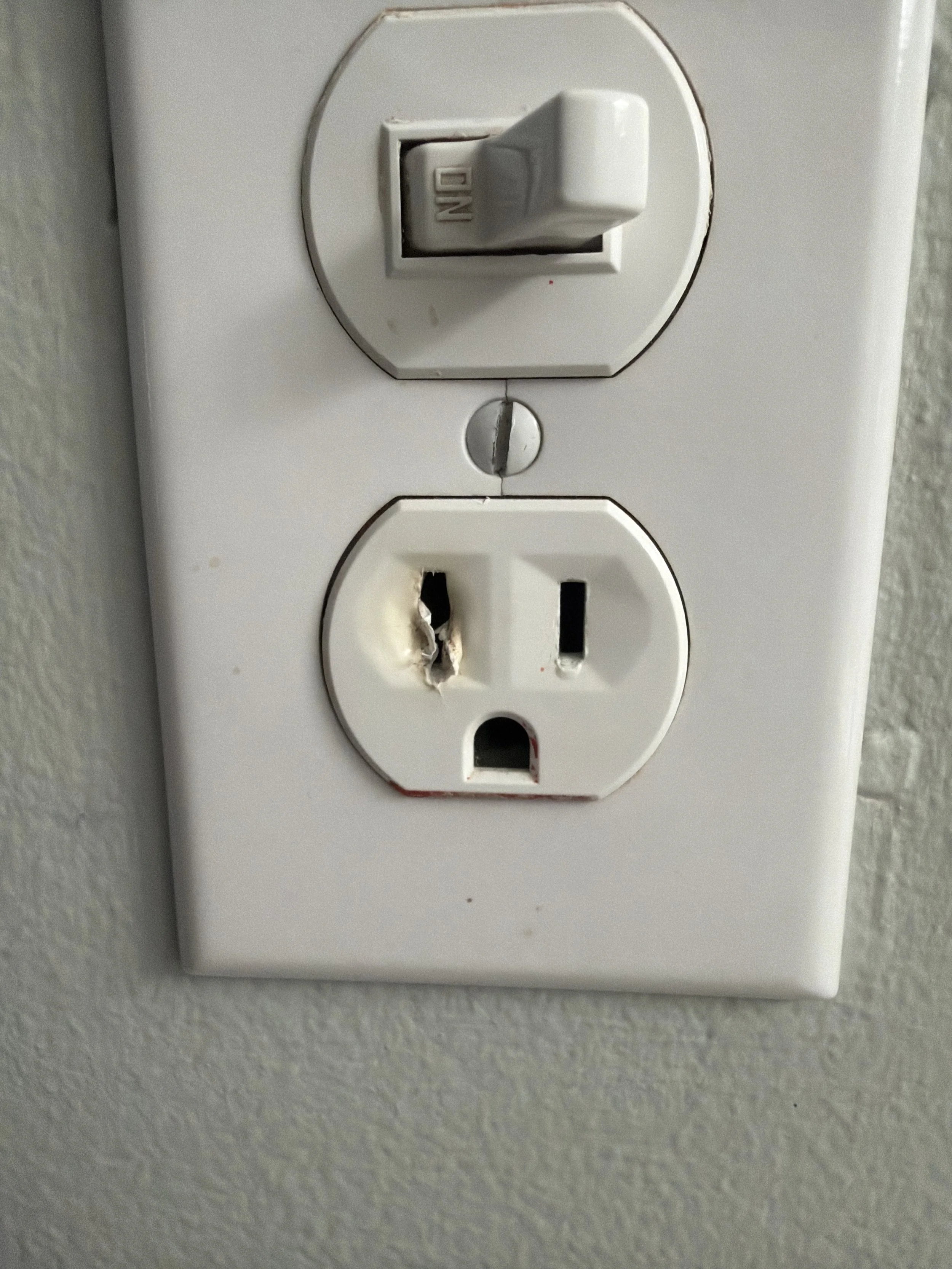 Receptacle and switch left clean behind a fresh plate in a Suffolk, VA home