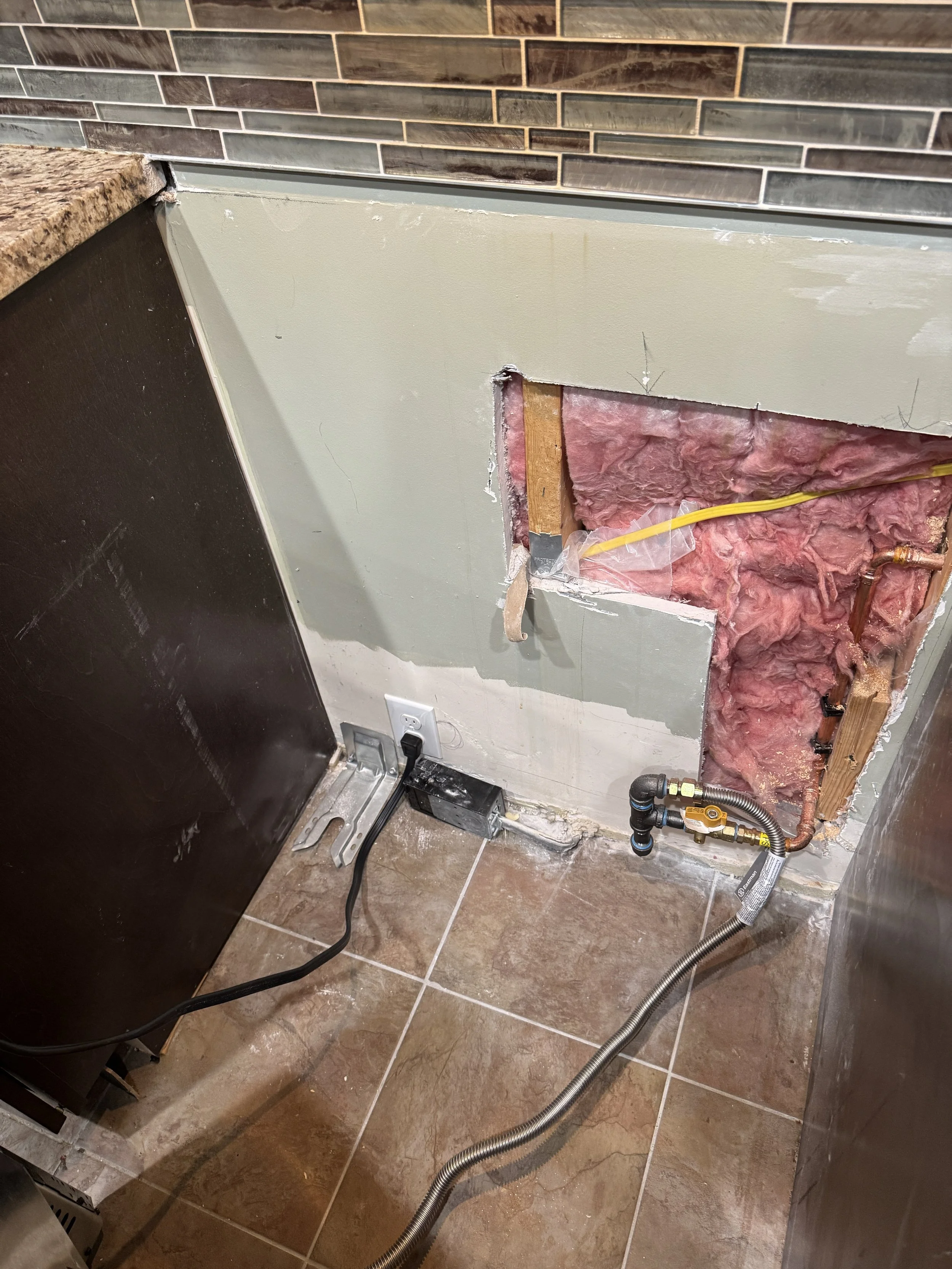 Kitchen appliance space opened up with the supply behind the cabinet in a Chesapeake, VA home