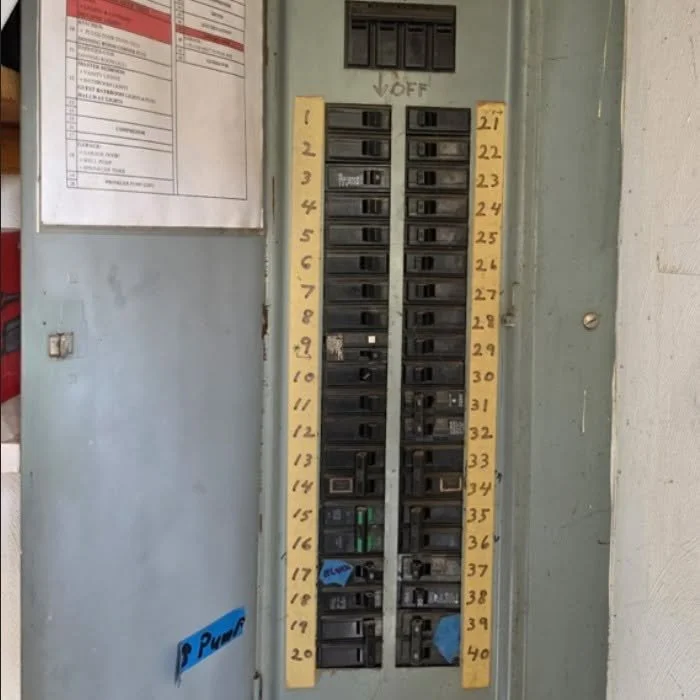Panel with a numbered breaker directory beside its breakers