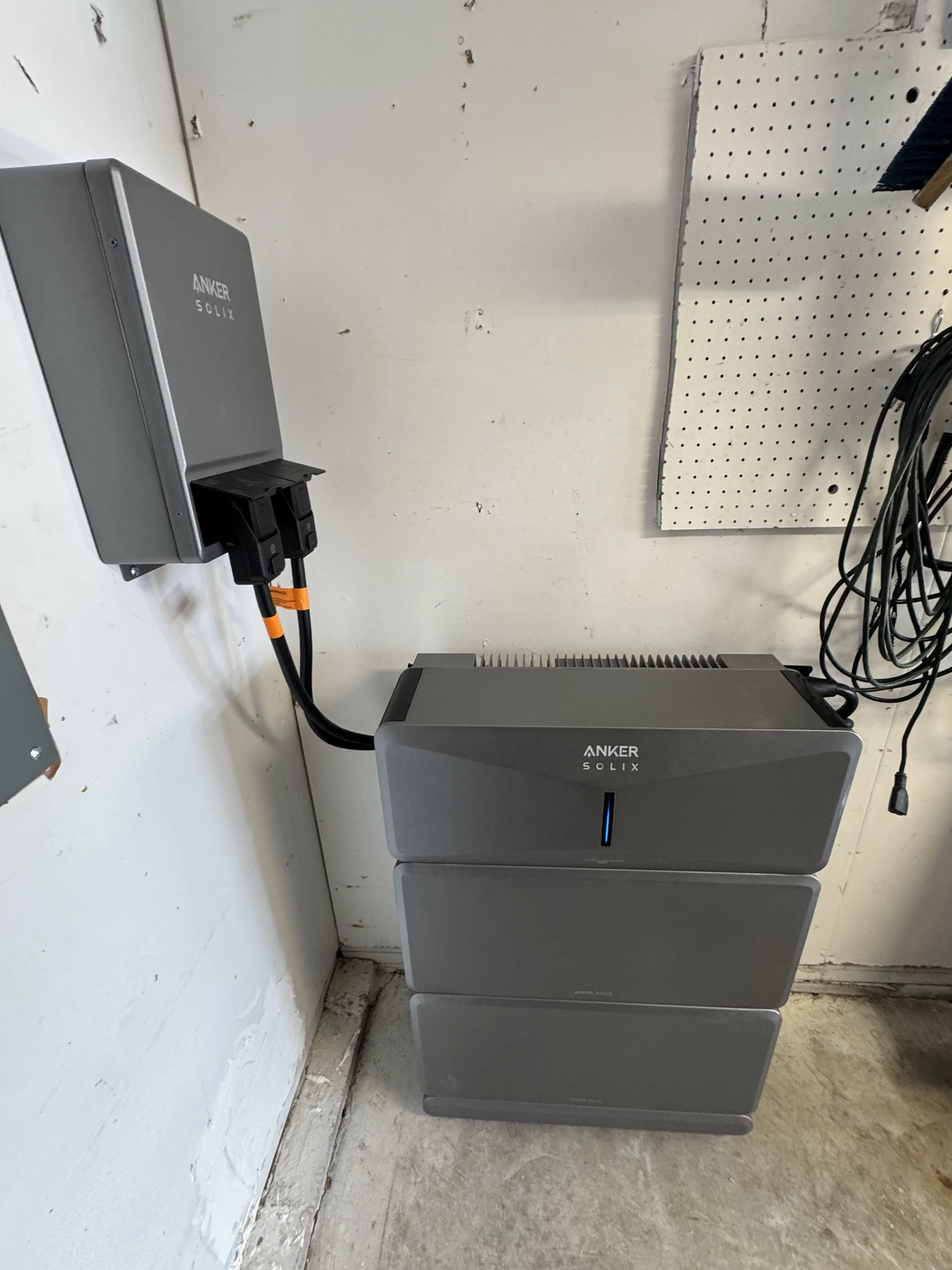 Stacked home battery units and their wall-mounted switching box on a Suffolk, VA property