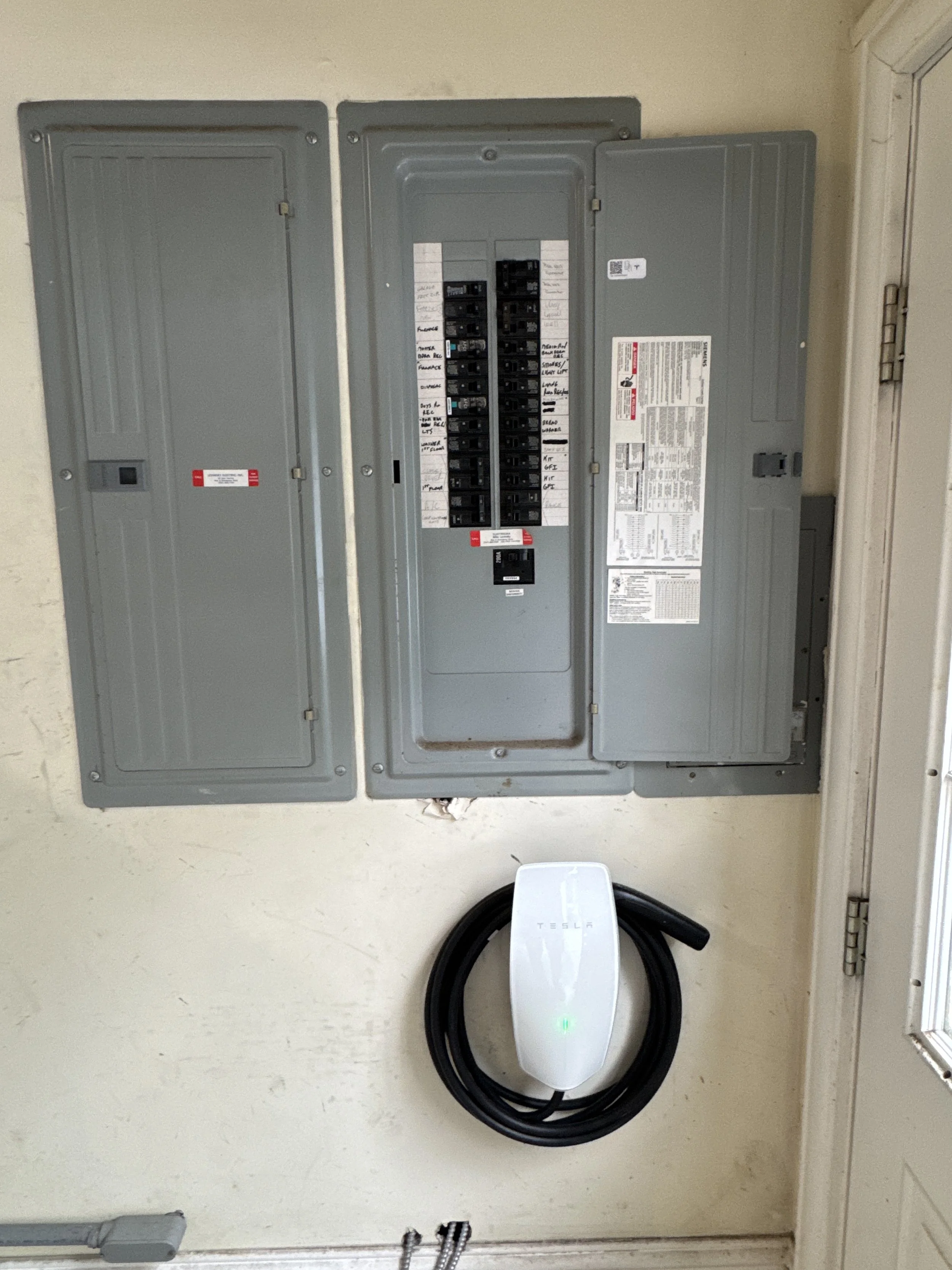 Subpanel set beside the main panel on a garage wall in Portsmouth, VA