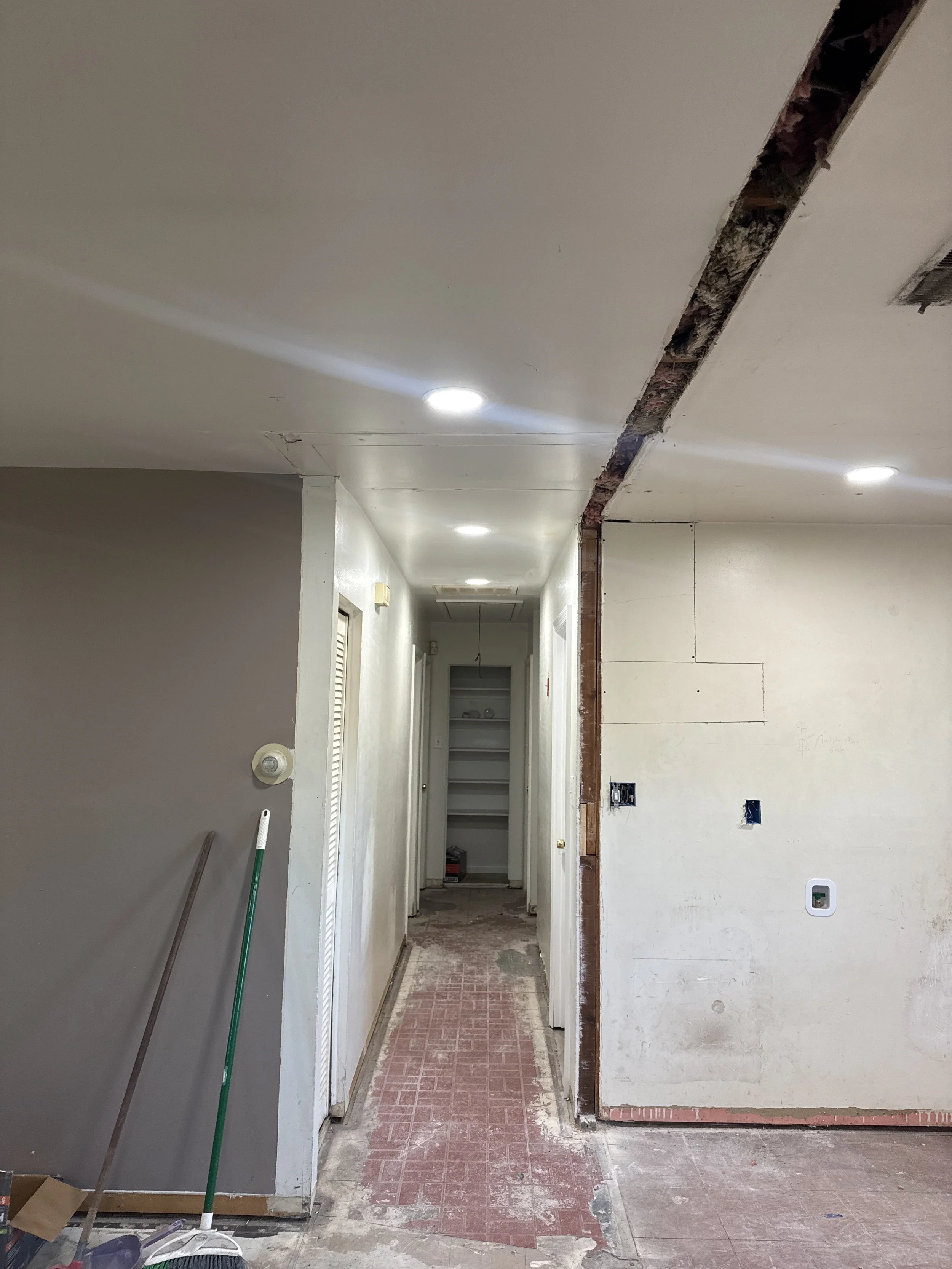Hallway in an older Portsmouth, VA home with the wall opened along the ceiling line