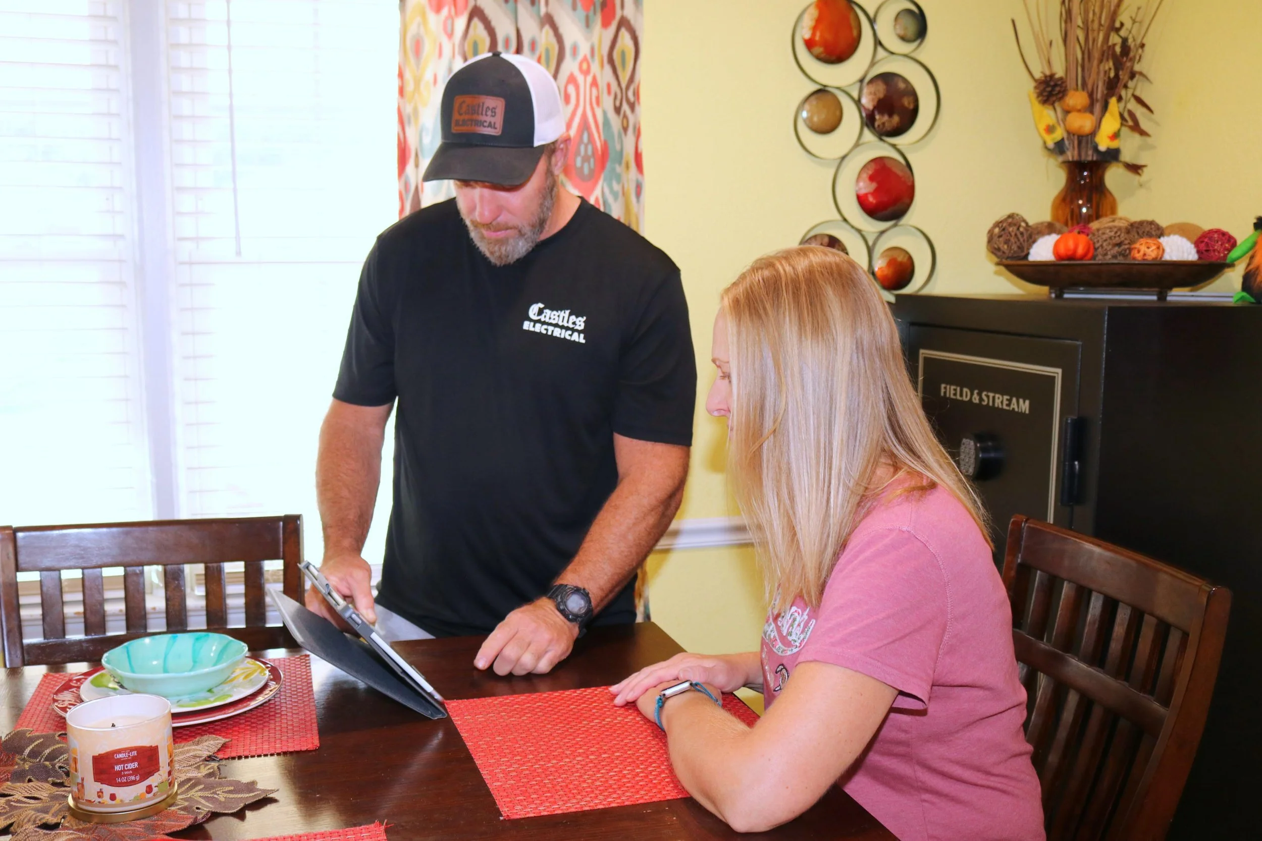 Castles Electrical electrician going through a written estimate with a Portsmouth, VA homeowner