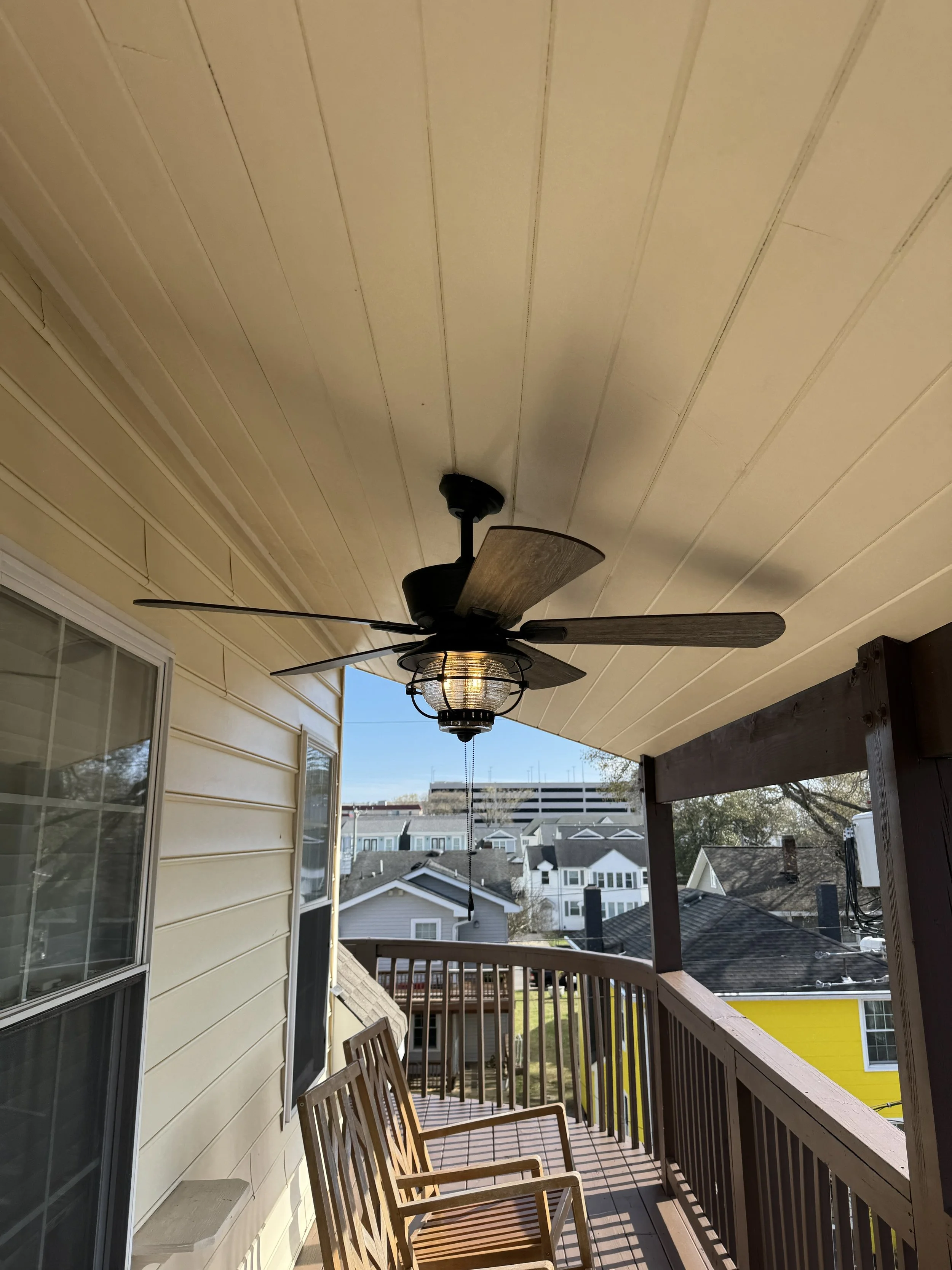 Lit ceiling fan fixture on a covered porch at a Norfolk, VA home