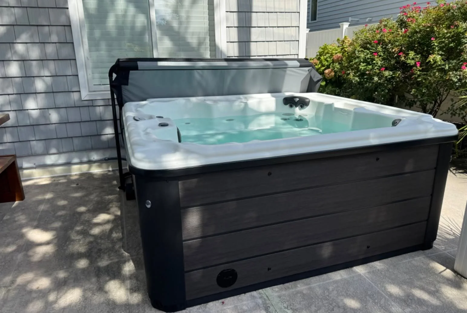 Hot tub set on a pad beside a Suffolk, VA home