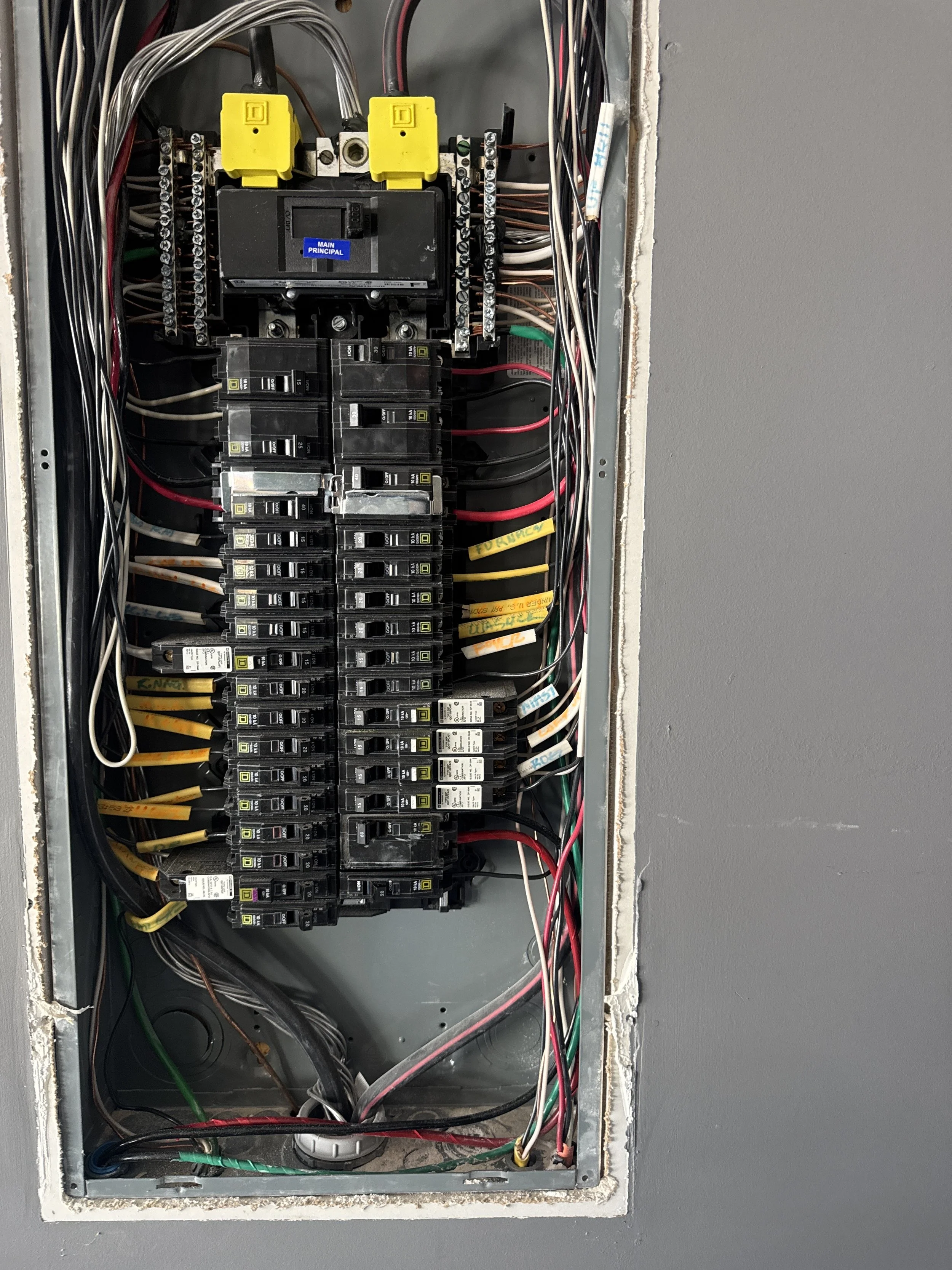 Panel cover off, with the neutral and ground conductors landed on separate bars