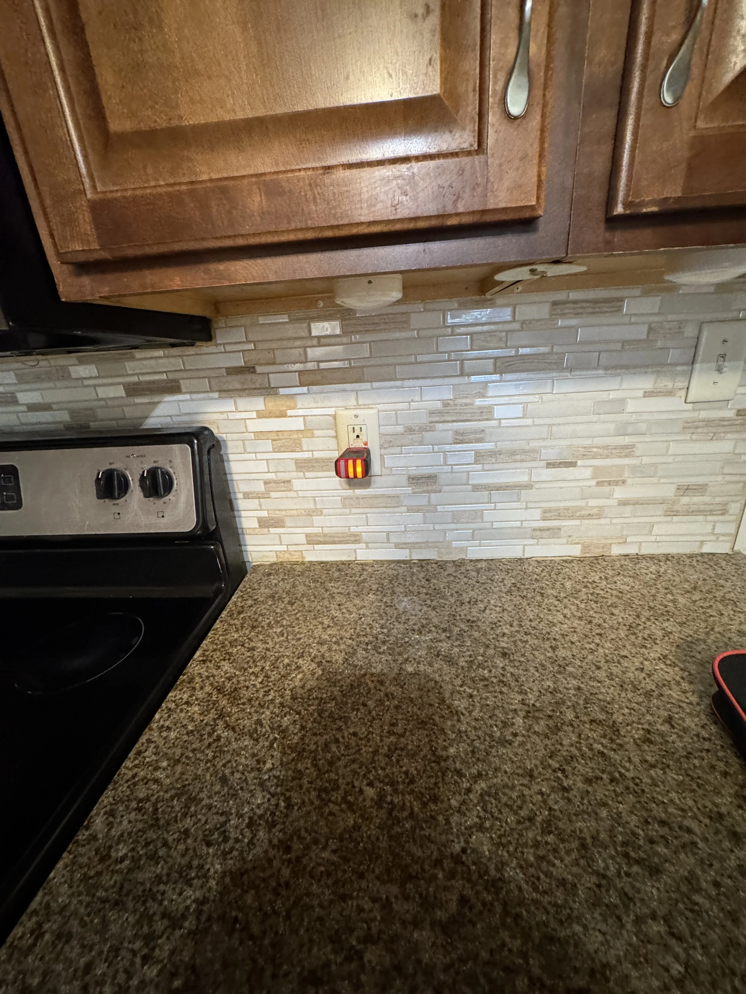 Receptacle on the backsplash beside an electric range in a Chesapeake, VA kitchen