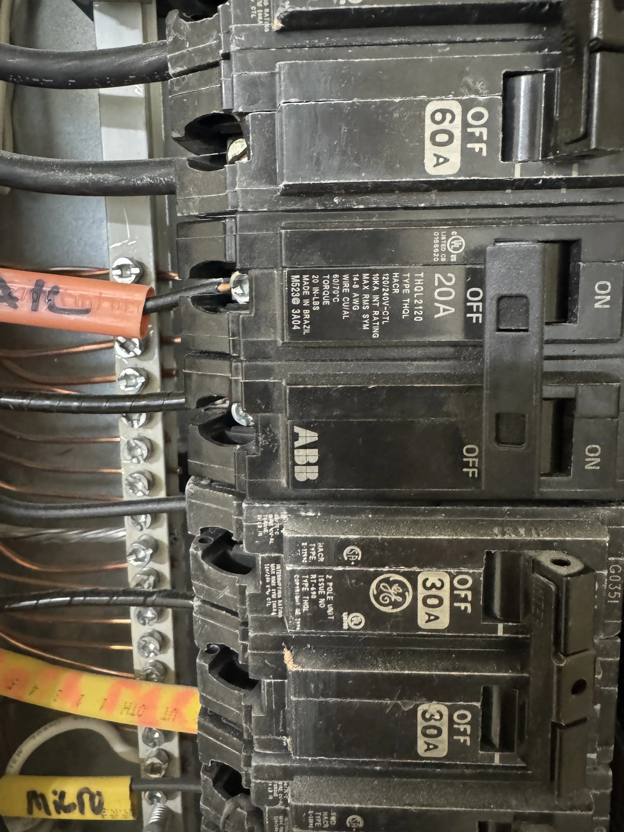 Close view of breaker faces and the markings printed on them inside a panel