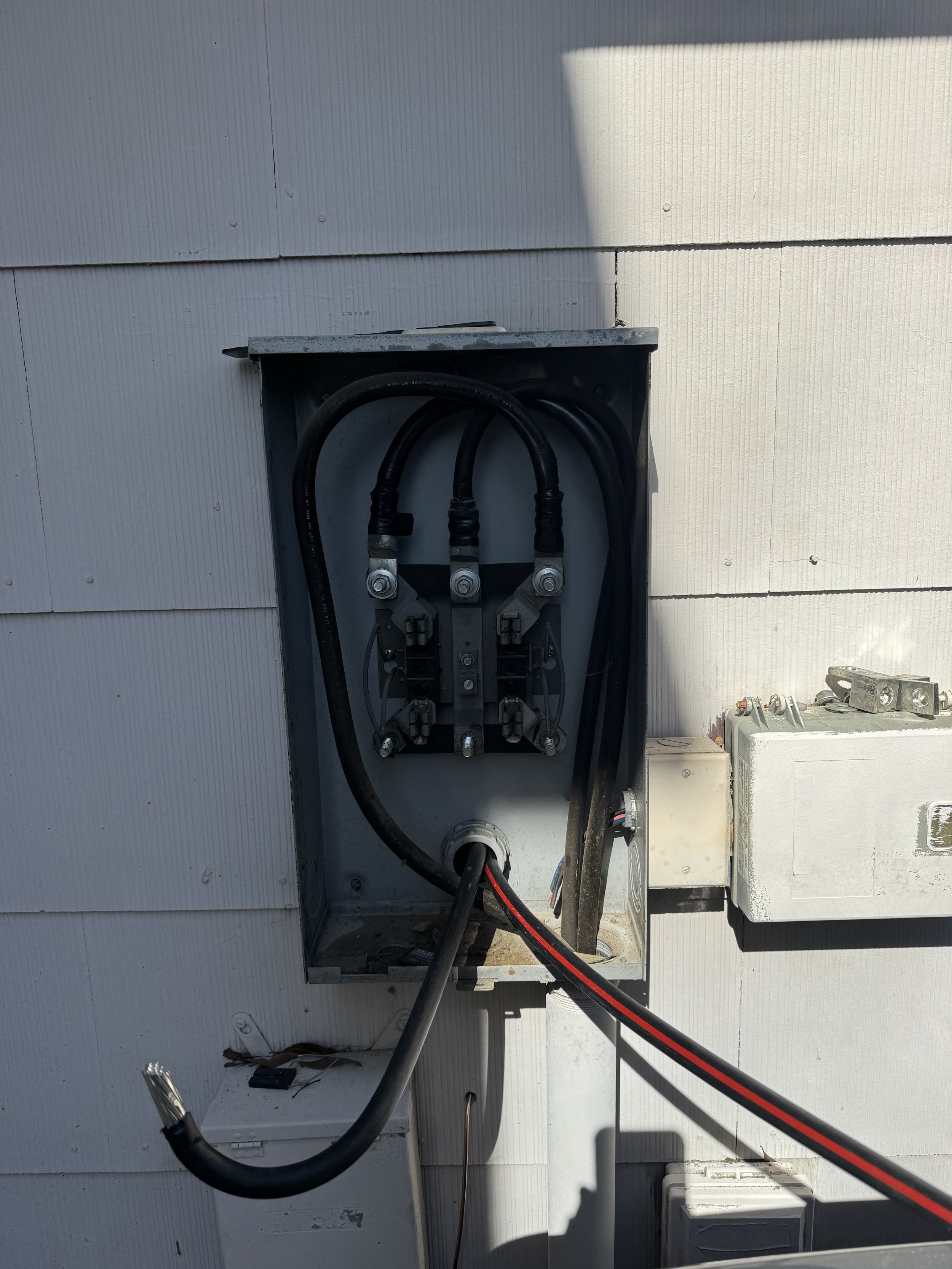 Service conductors entering the meter enclosure on a Portsmouth, VA home