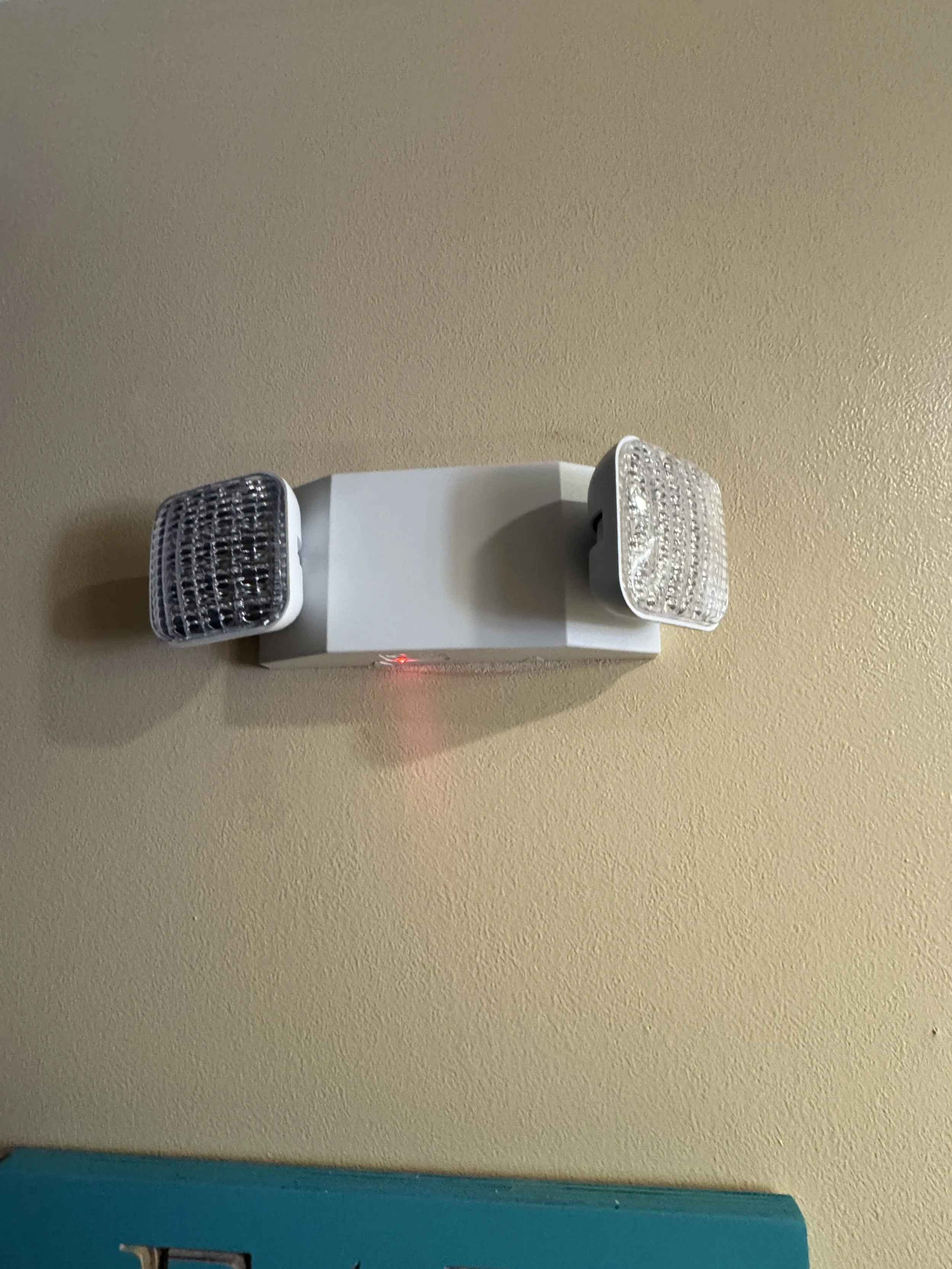 Emergency lighting unit mounted and working in a business space