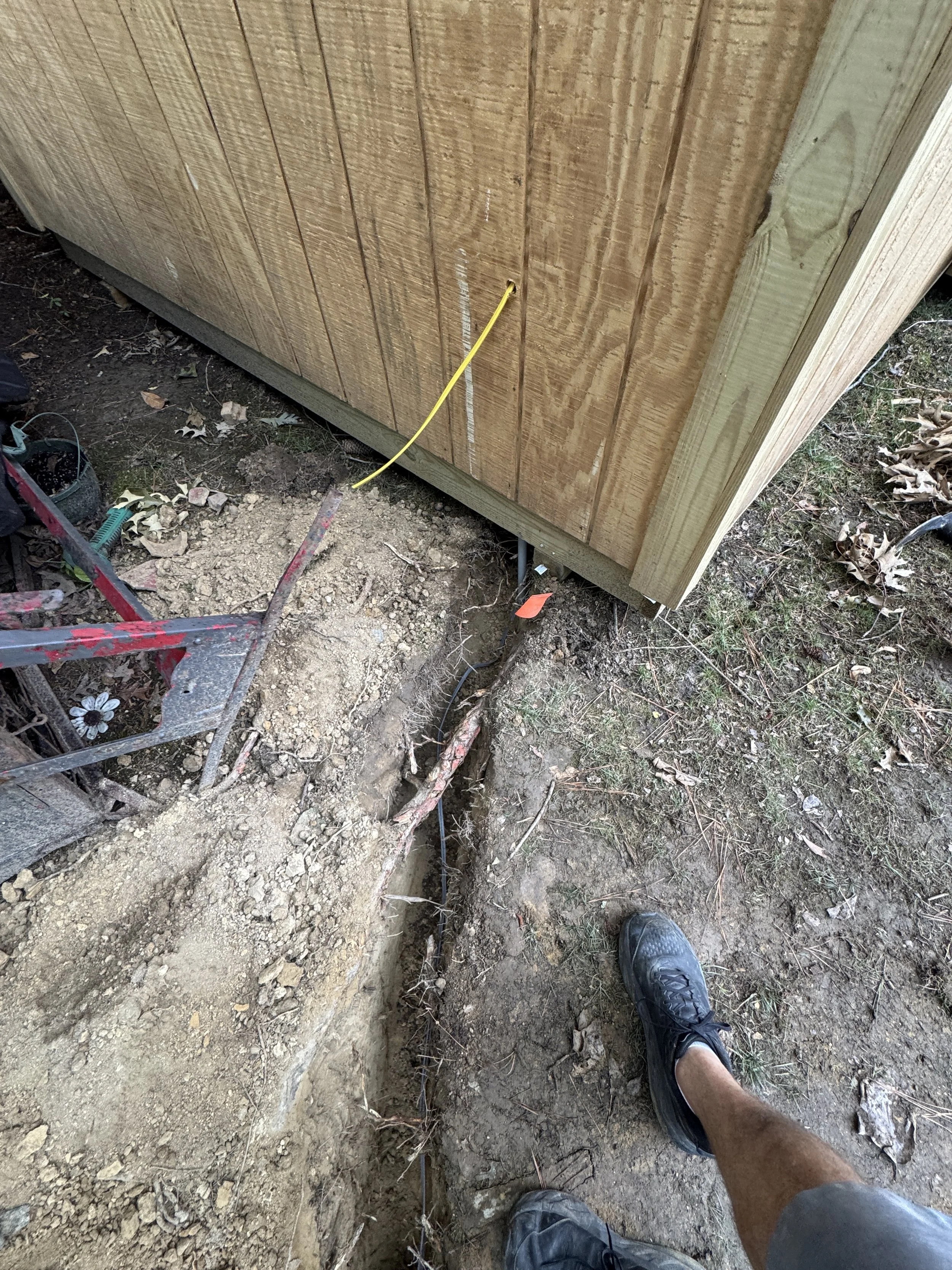 Feeder trench arriving at the wall of a detached building in Suffolk, VA