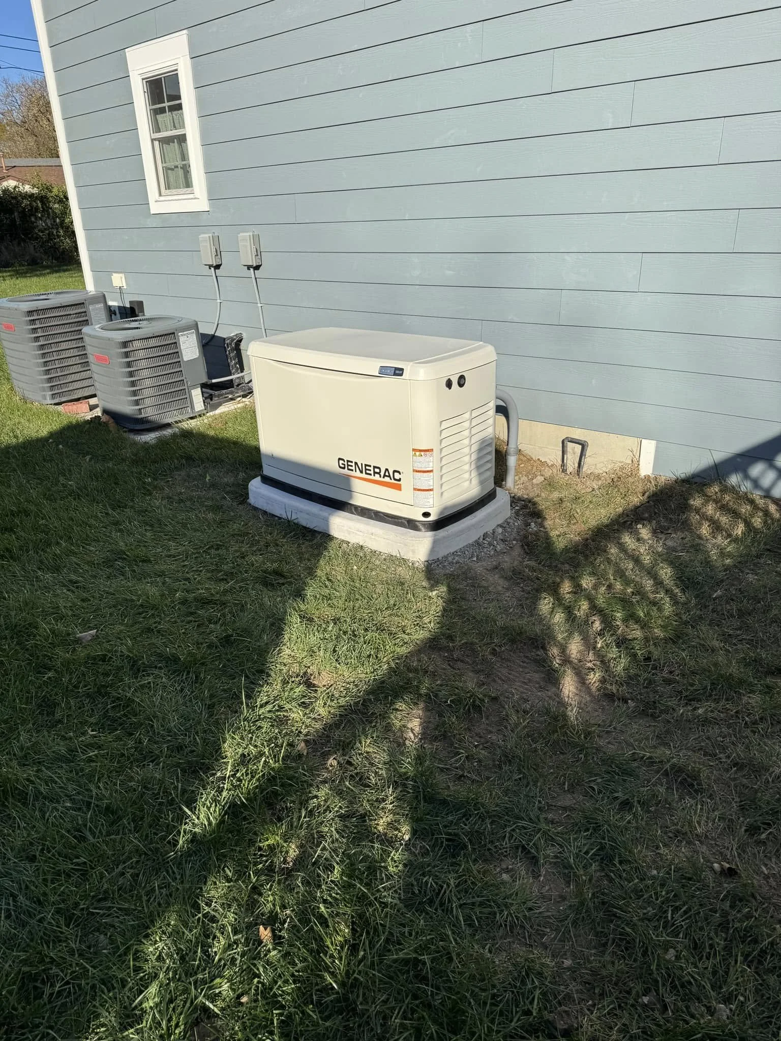 Generator pad placed clear of the propane tank and other equipment on a Suffolk, VA property