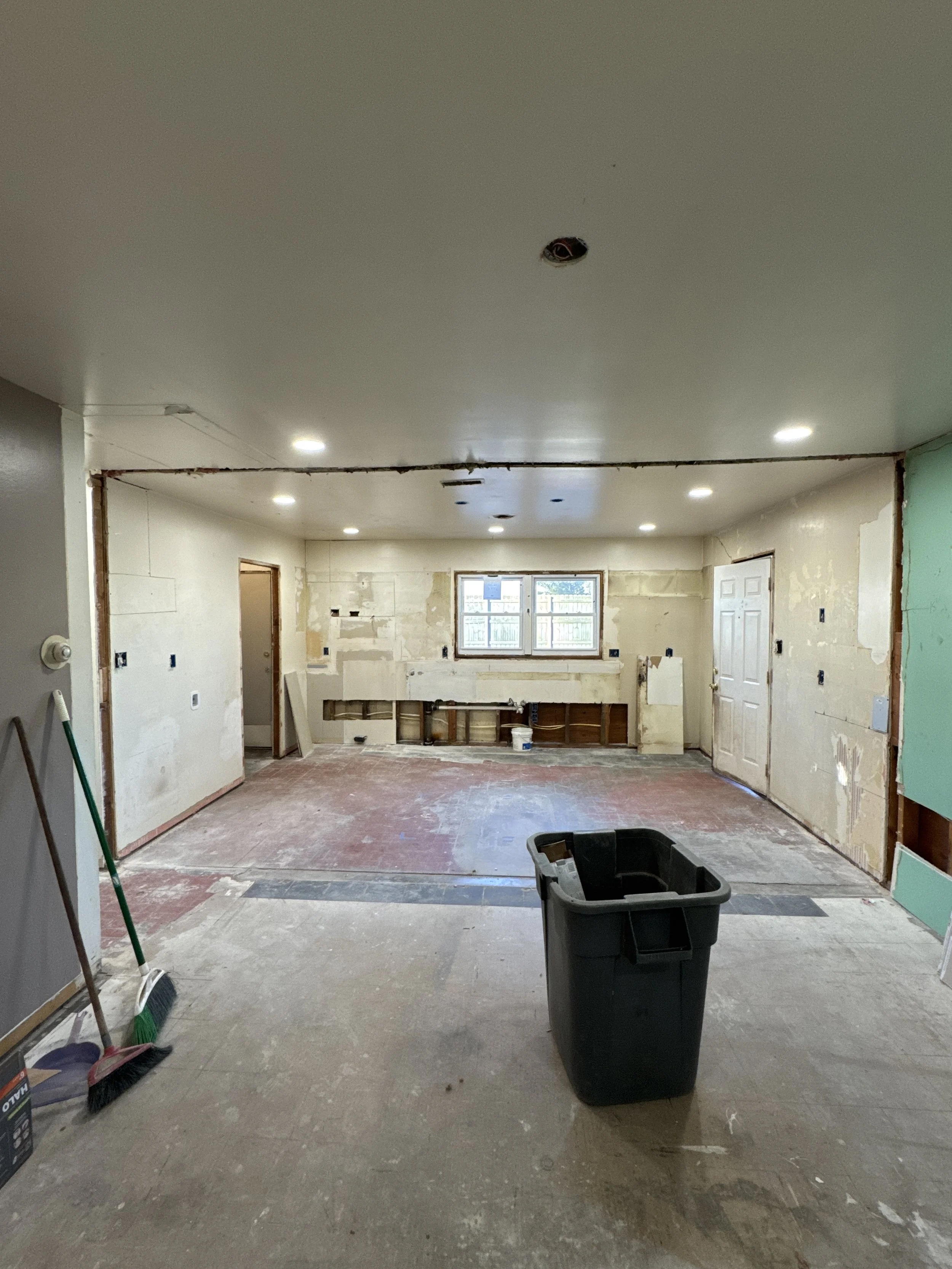 Rooms of an older Chesapeake, VA home stripped back to bare walls during a rewire