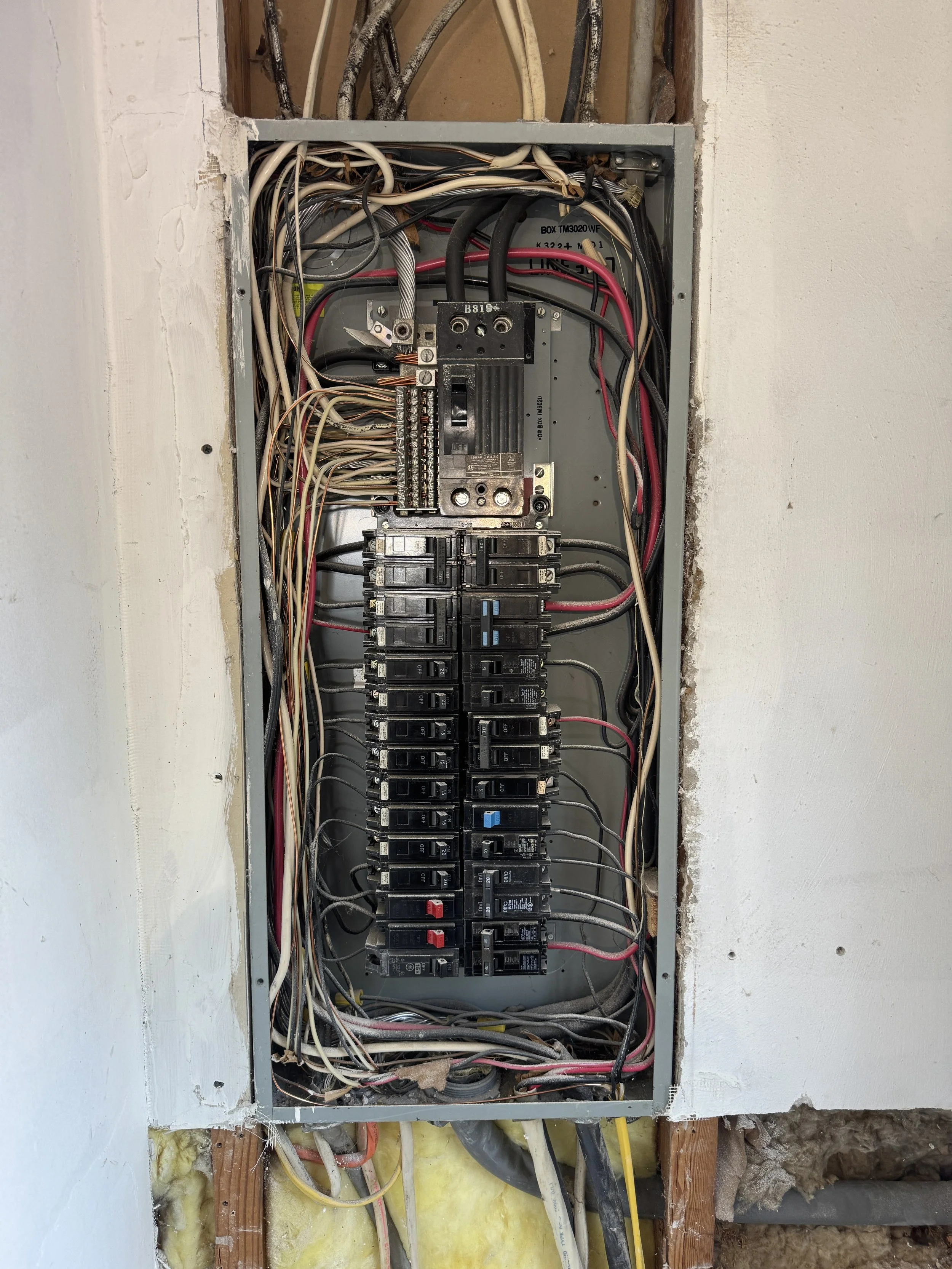 Older panel opened up with decades of earlier circuits still landed on it
