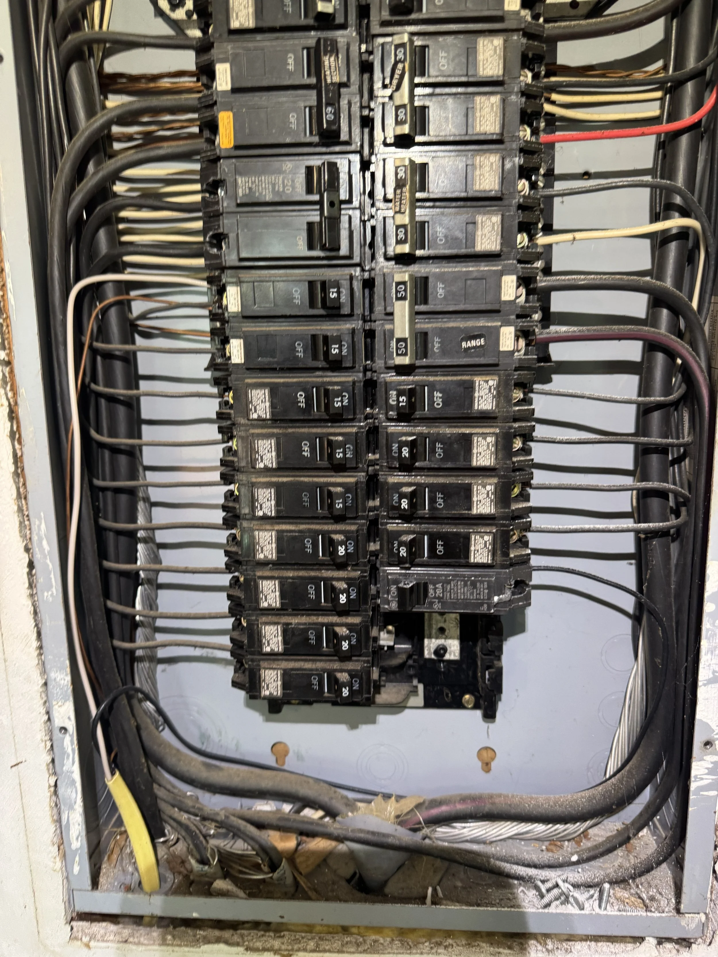 Crowded older panel inside a Portsmouth, VA house before replacement