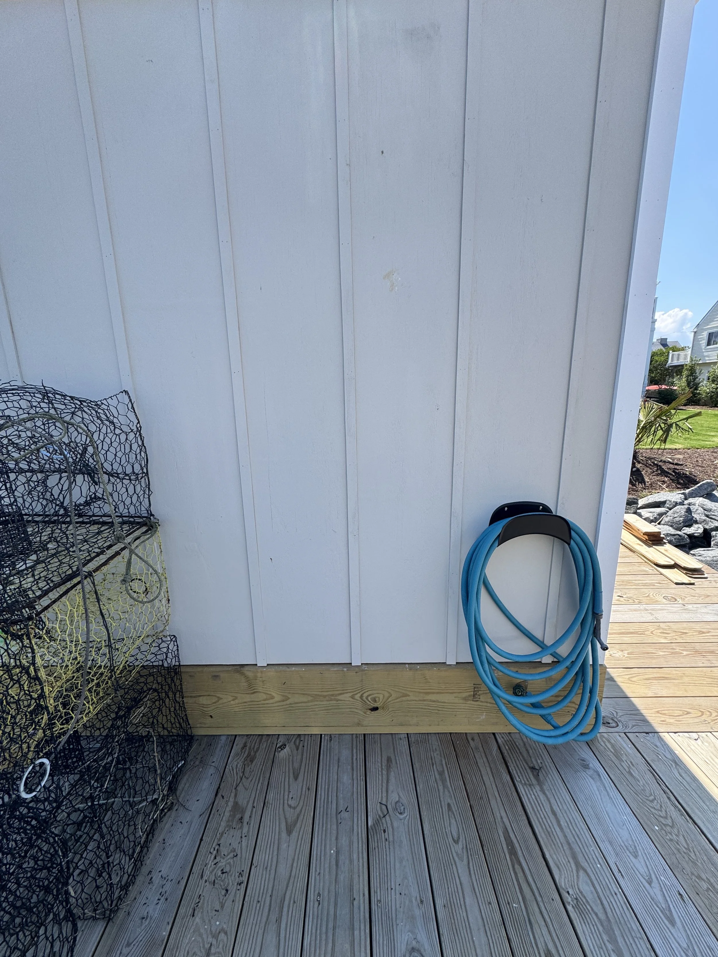 Pier decking beside the side wall of a dock structure at a Norfolk, VA waterfront home