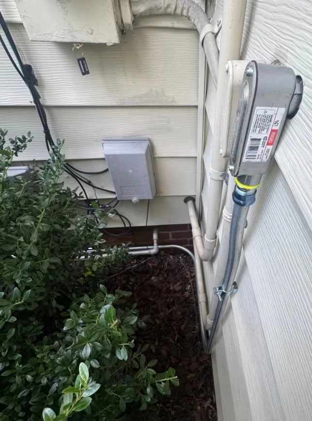 Service drop attached high under the eave of a Portsmouth, VA house