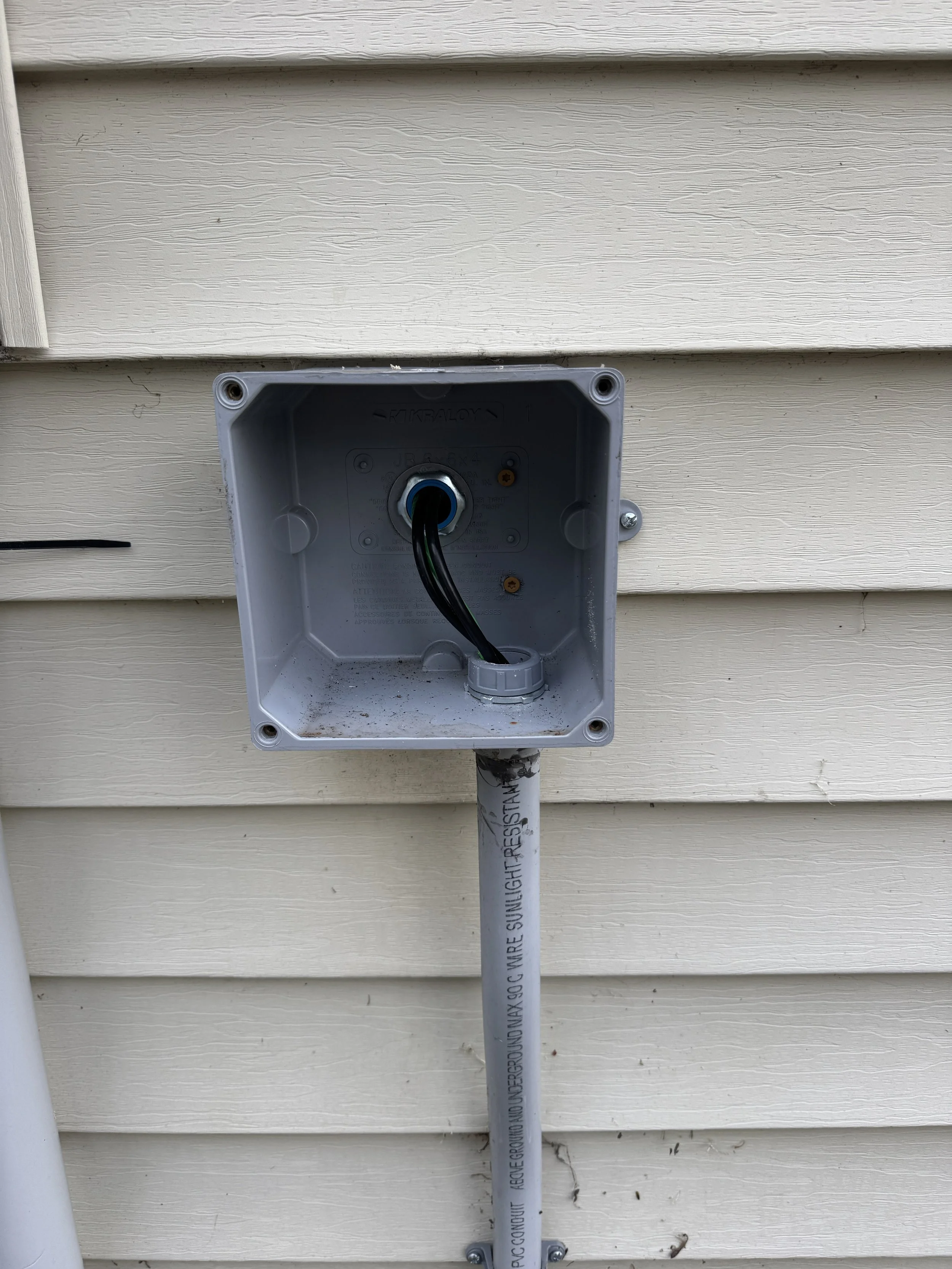 Weatherproof box on the wall of a Portsmouth, VA home where the charging circuit lands