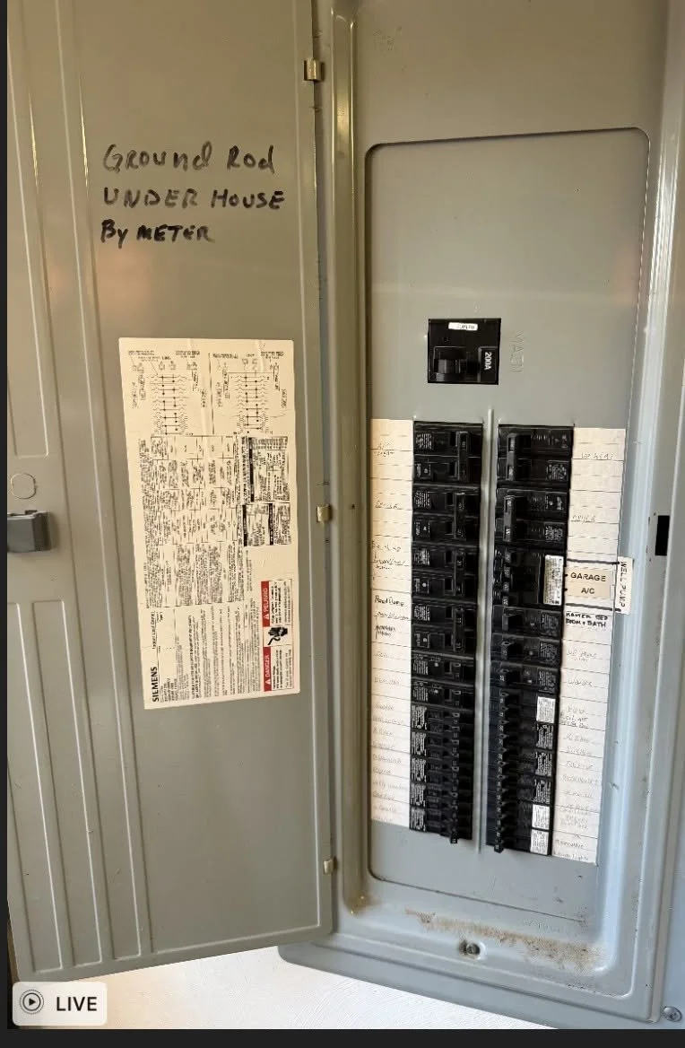 Panel with a handwritten breaker directory taped inside its door