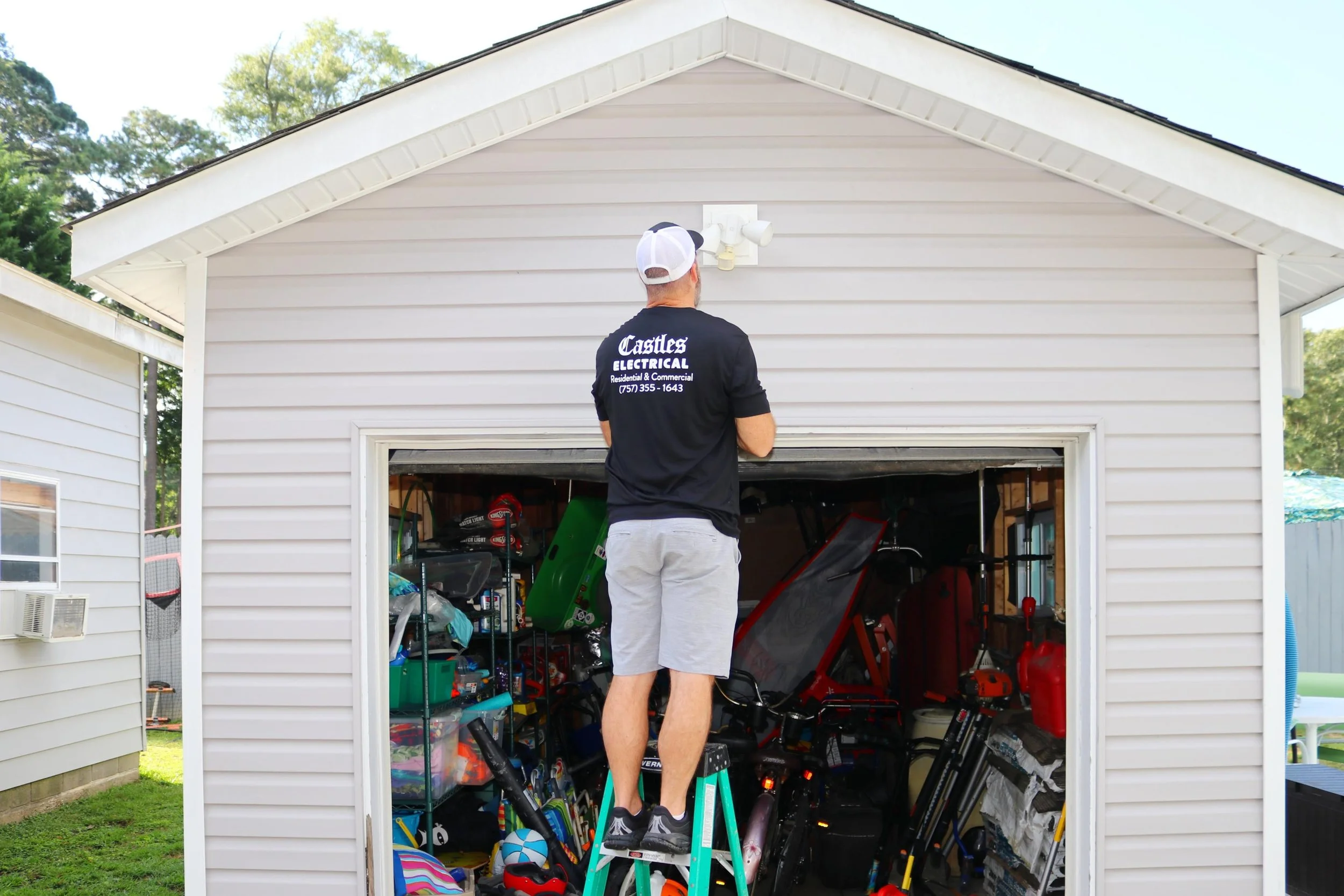 Castles Electrical electrician installing a light over a detached garage in Norfolk, VA