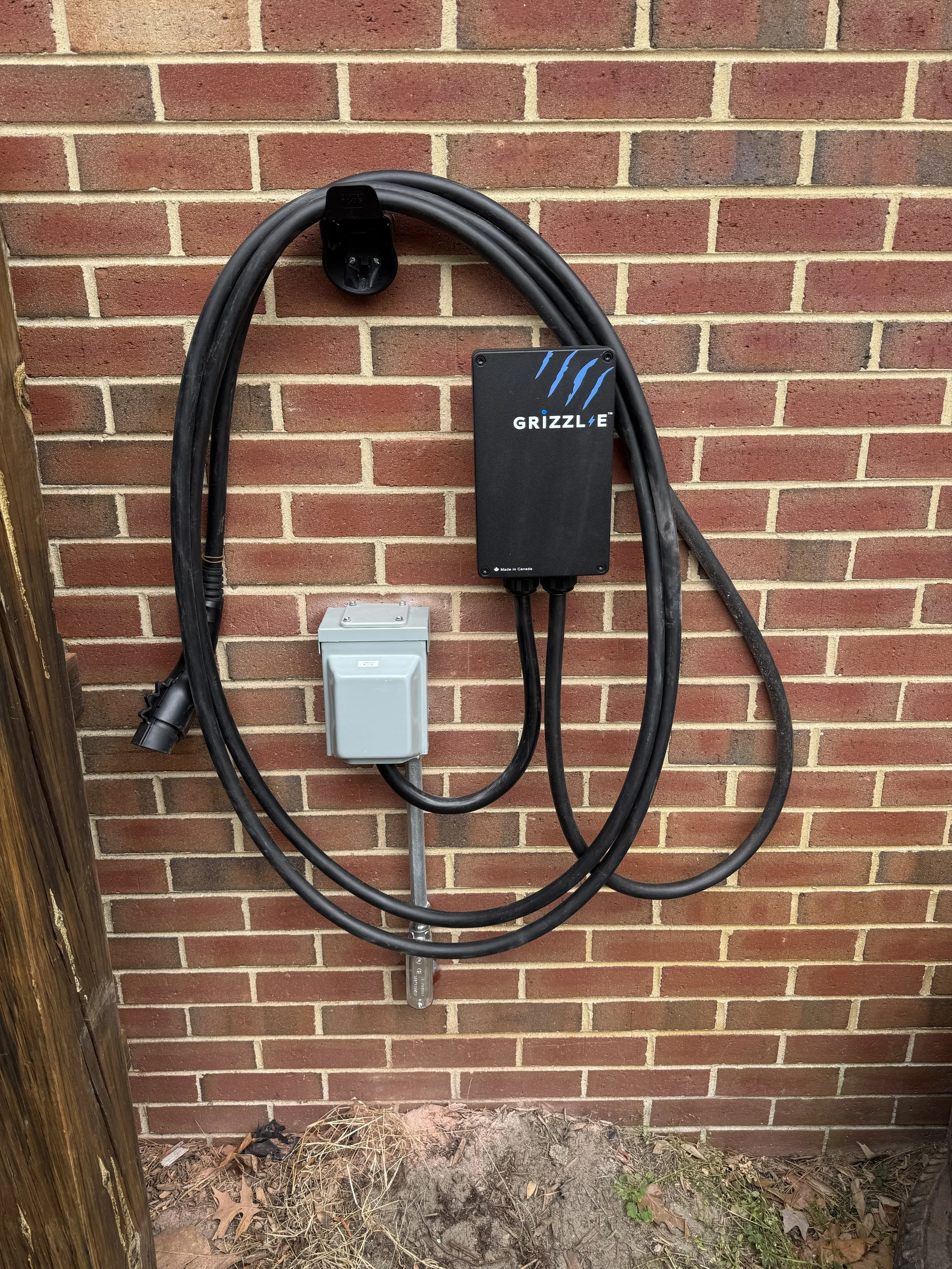 Charger mounted high on the brick wall of a Portsmouth, VA home