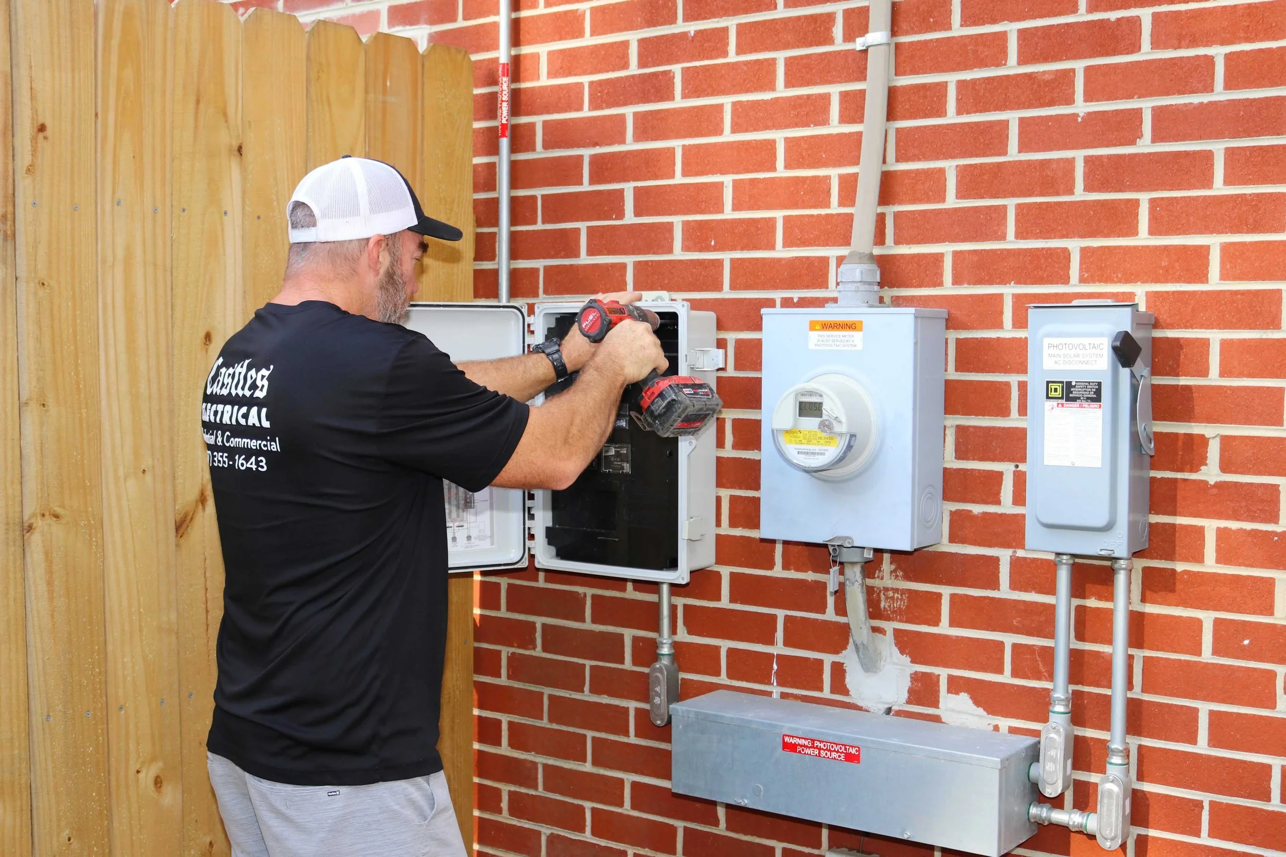 Castles Electrical electrician working at the service equipment of a Chesapeake, VA home