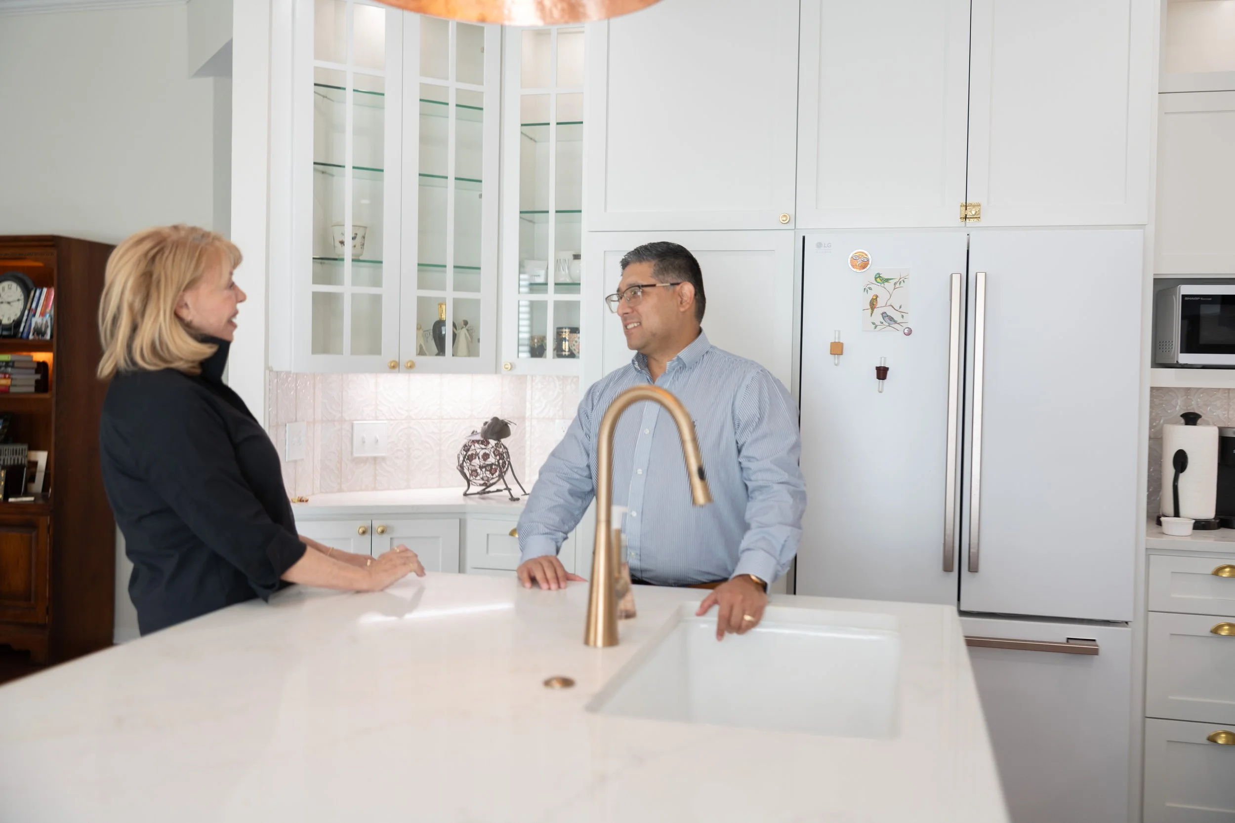 Joel Palacios reviewing a remodel with a homeowner