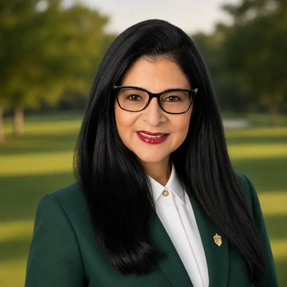 Professional portrait of Ixchetl Romero in a green blazer and white shirt.
