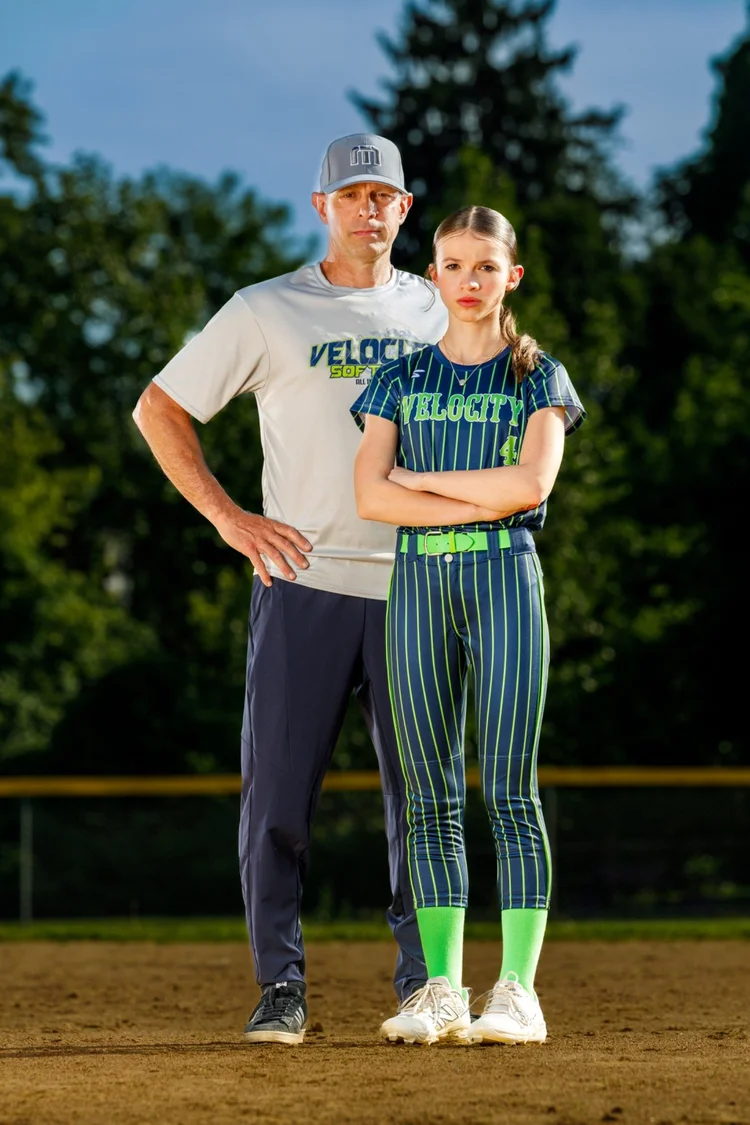 Softball player and coach portrait on the field