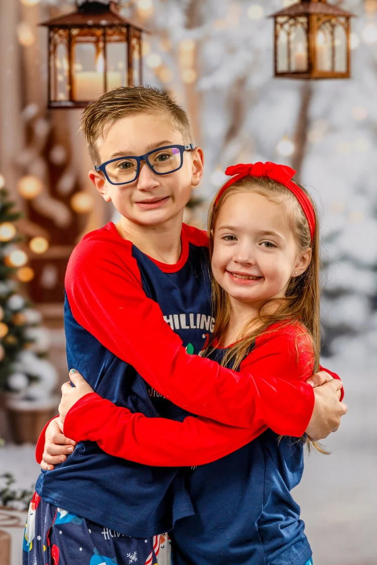 Siblings embracing during a Christmas portrait session