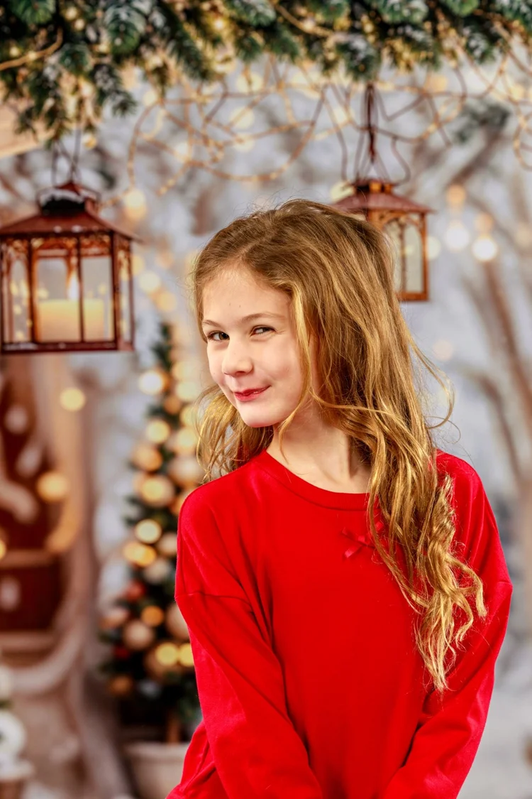 Child in red posing during a holiday portrait session
