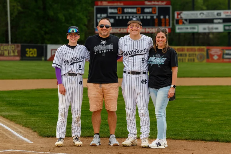Baseball players with family on the field in Homer City, Pennsylvania