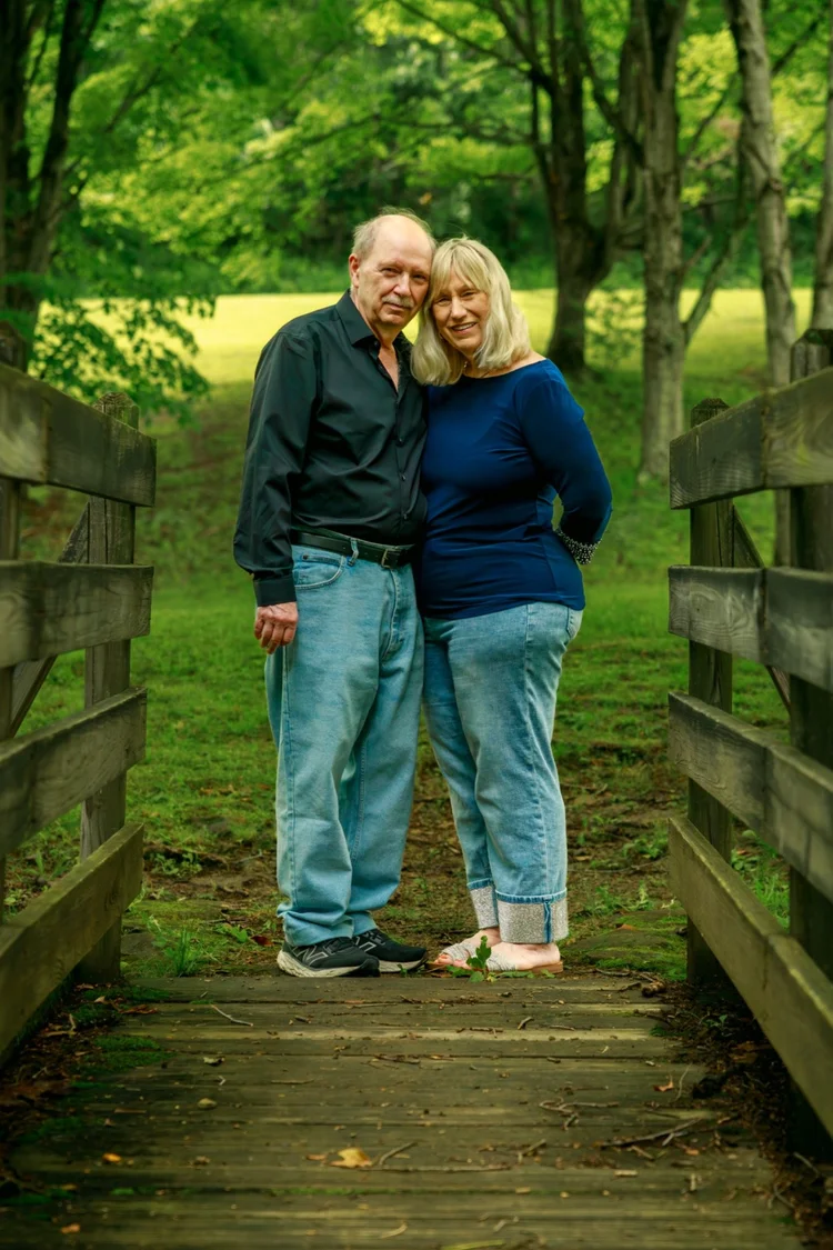 Couple portrait on a wooded footbridge