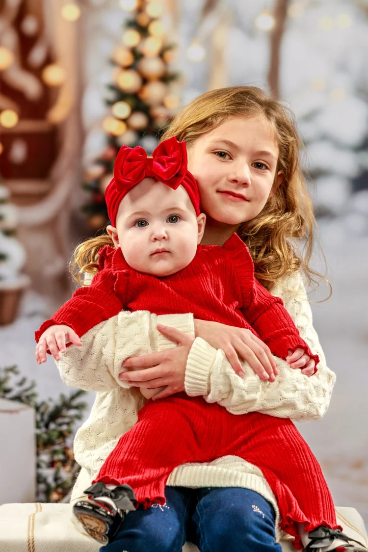 Sisters wearing red during a Christmas portrait session
