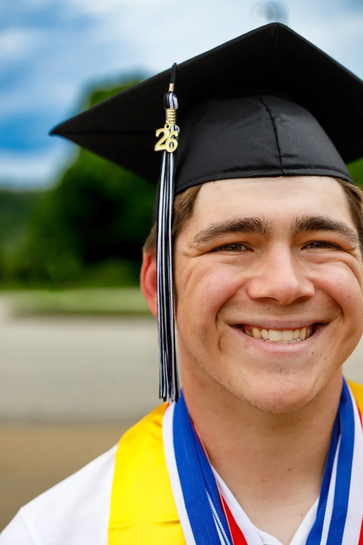 Smiling high school senior portrait in graduation cap
