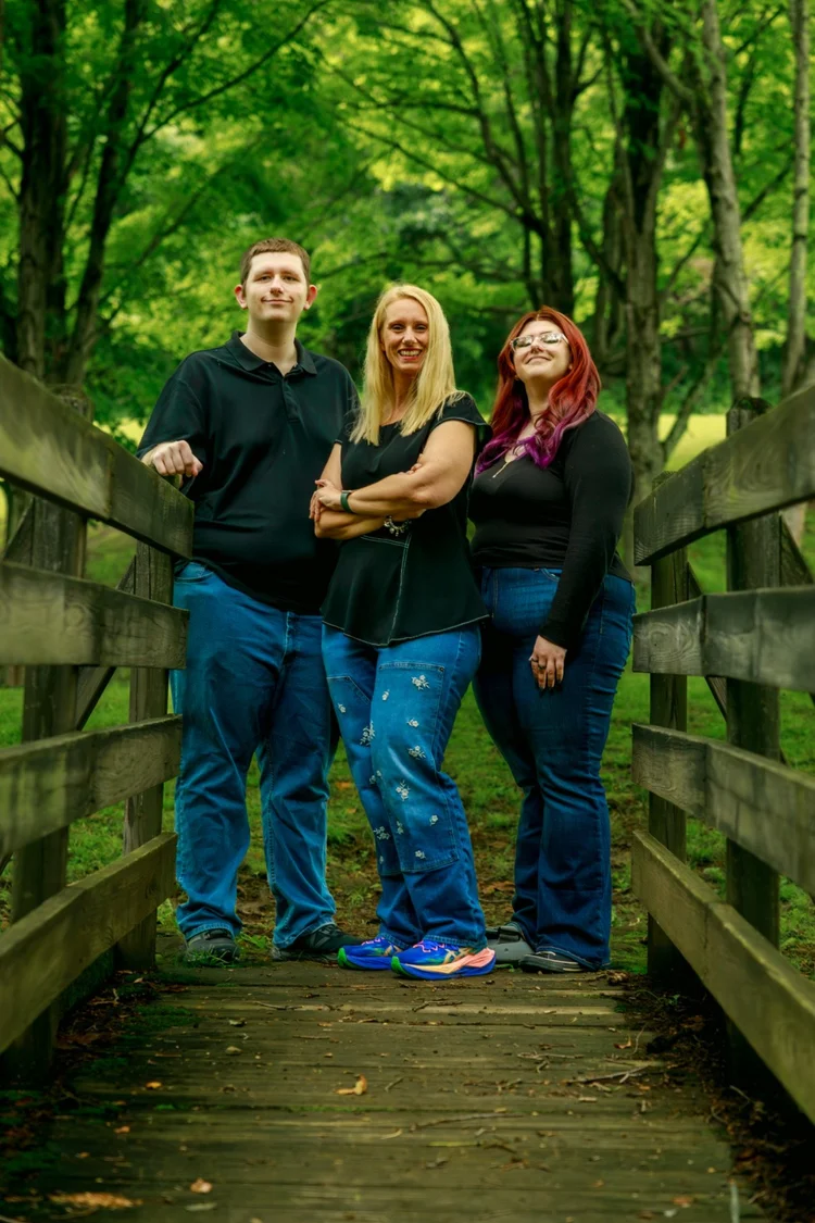 Family portrait on a wooded footbridge