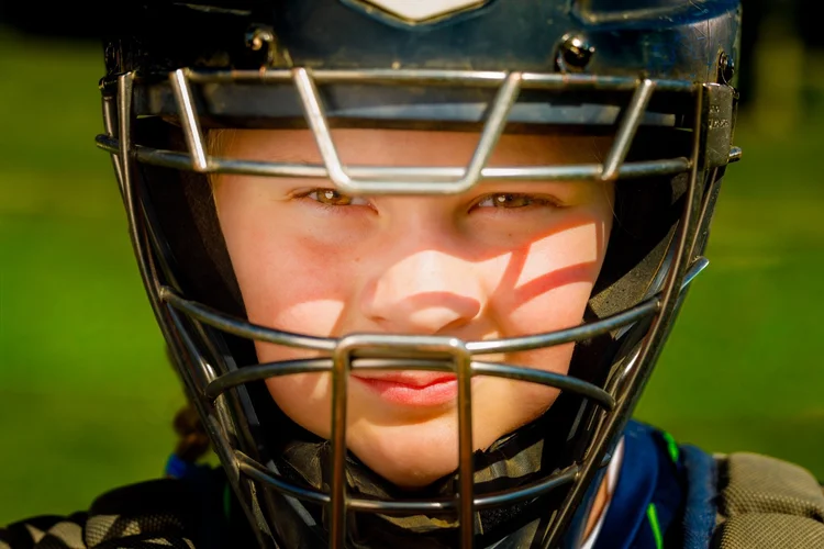 Close-up portrait of a youth softball catcher