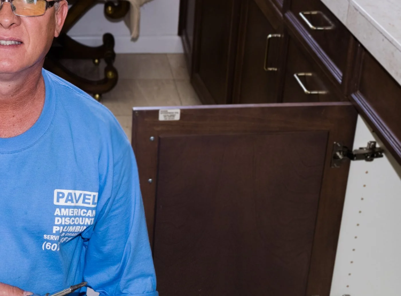 Pavel Farcas replacing a bathroom vanity fixture in a Camelback East home.