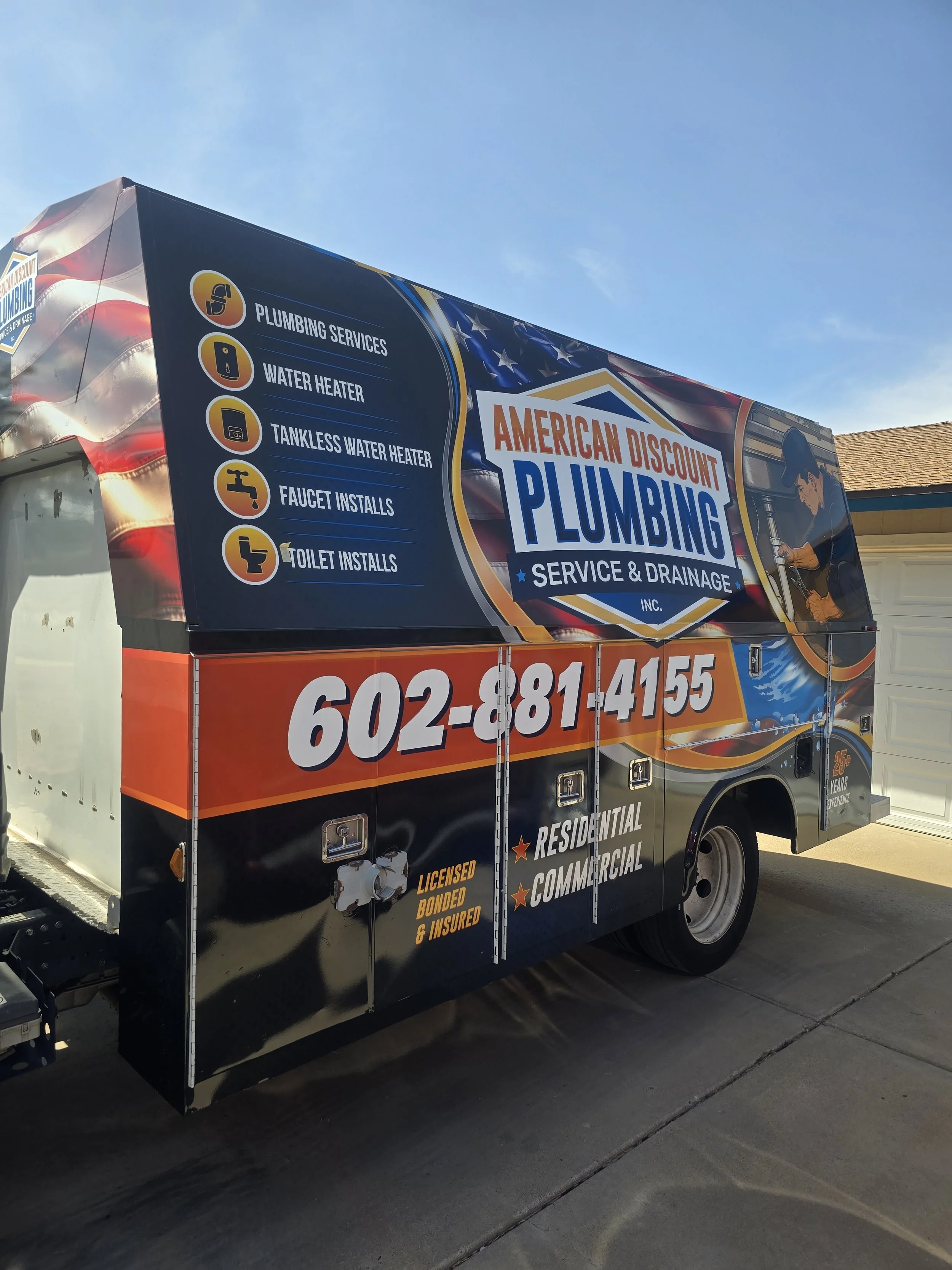 Pavel Farcas selecting a replacement part from the American Discount Plumbing service truck.
