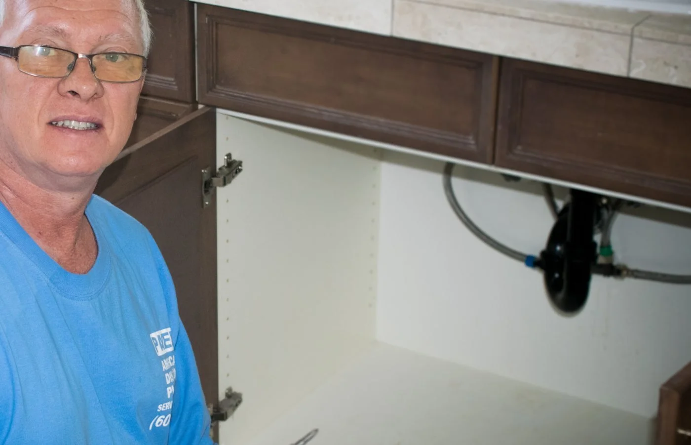 American Discount Plumbing servicing a toilet in a Phoenix bathroom.