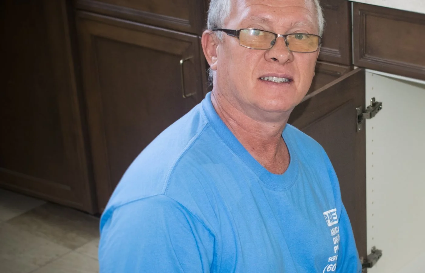 Pavel Farcas replacing a bathroom vanity fixture in a Cave Creek home.