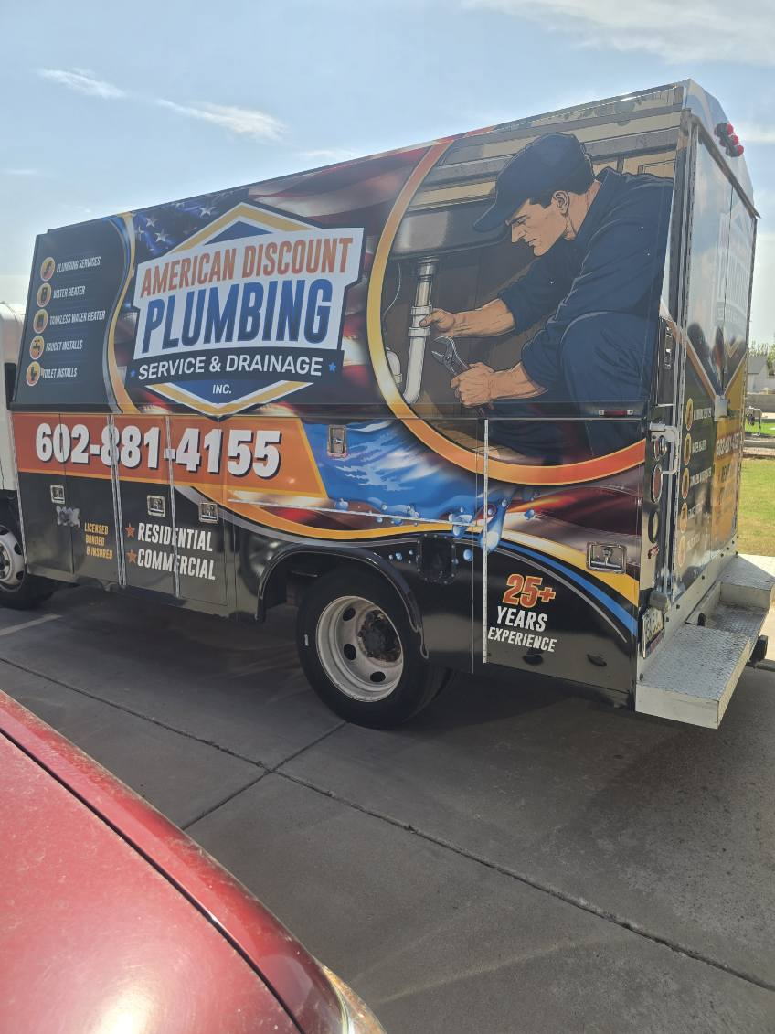 American Discount Plumbing repairing supply lines under a Phoenix kitchen sink.